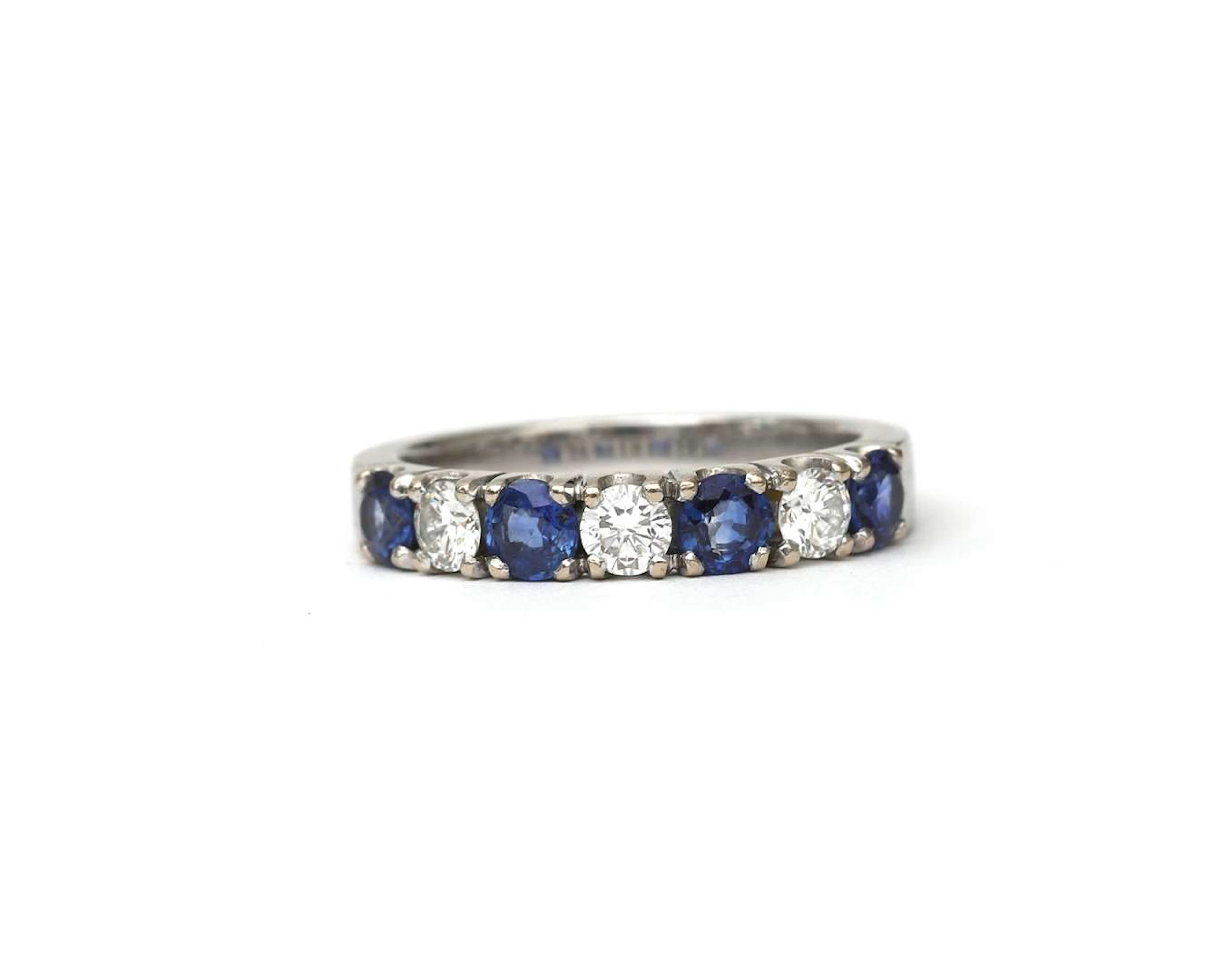 An 18k white gold ring set with a sapphire and a diamond, early 21st century