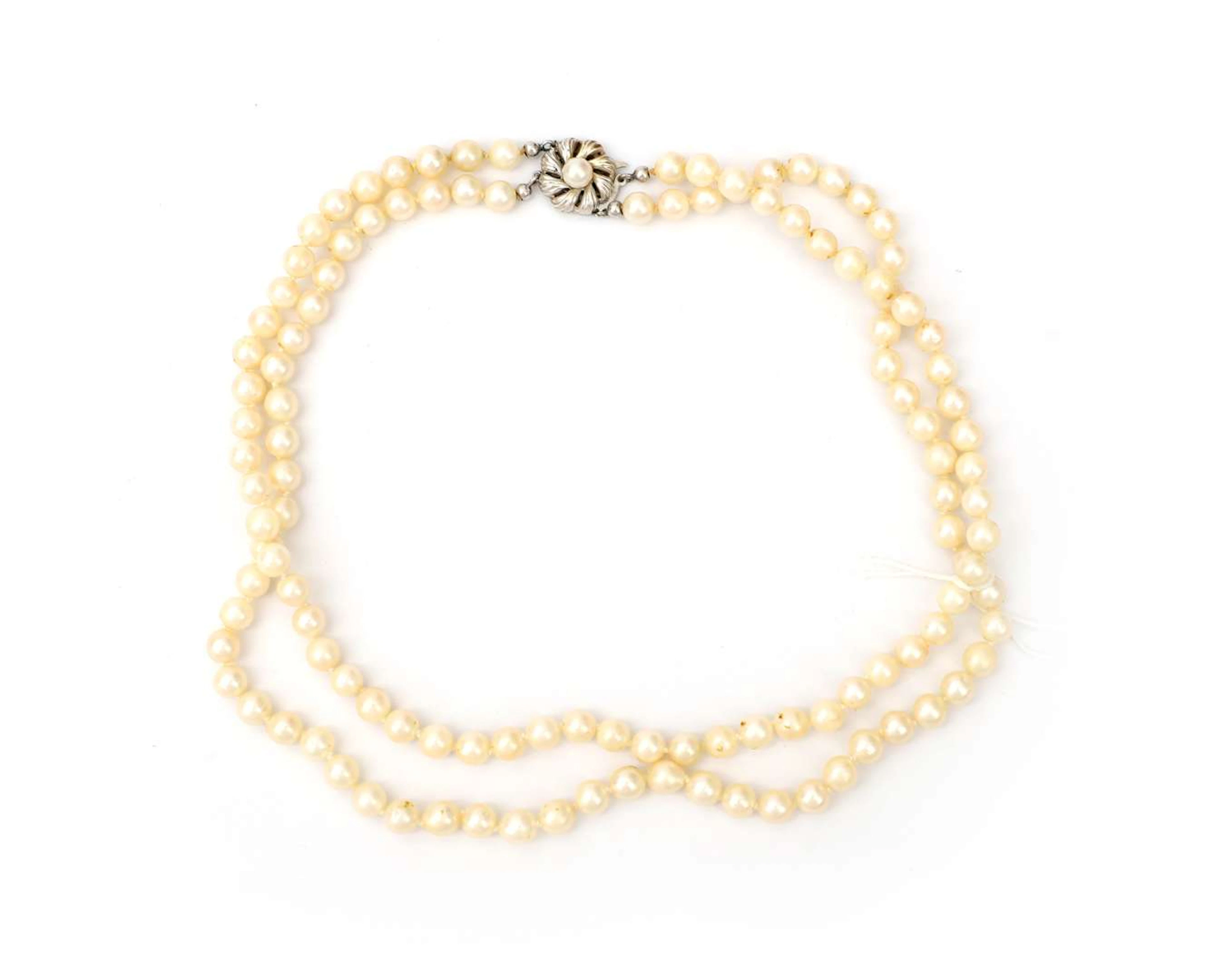 A double-strand pearl necklace with a 14 k white gold clasp