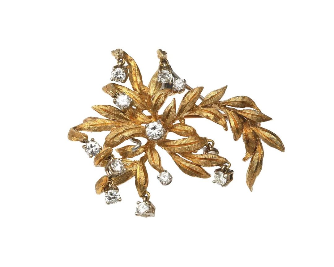 An 18-carat yellow gold floral brooch set with a diamond