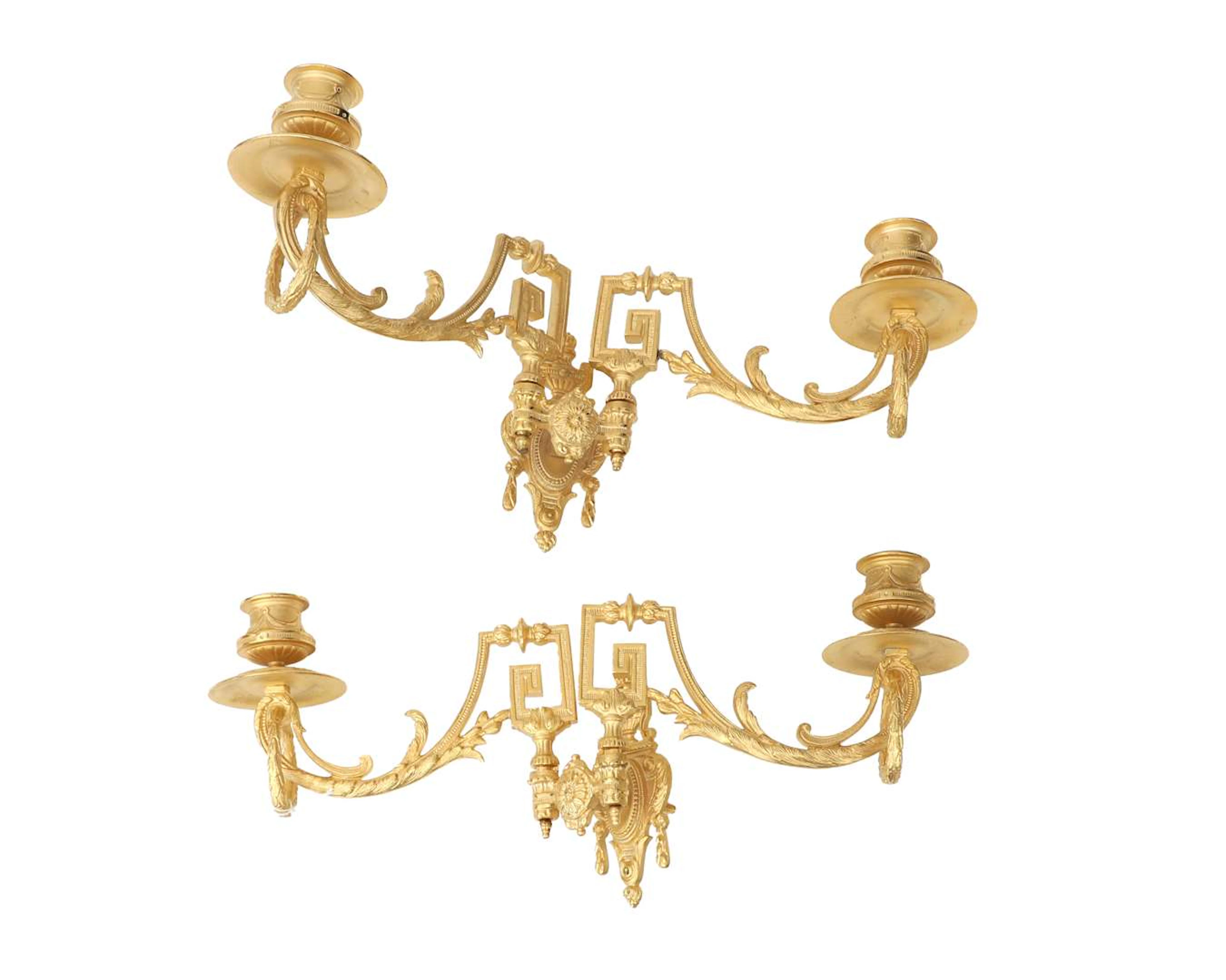 A pair of gold-coloured metal two-light piano candlesticks. Marked
