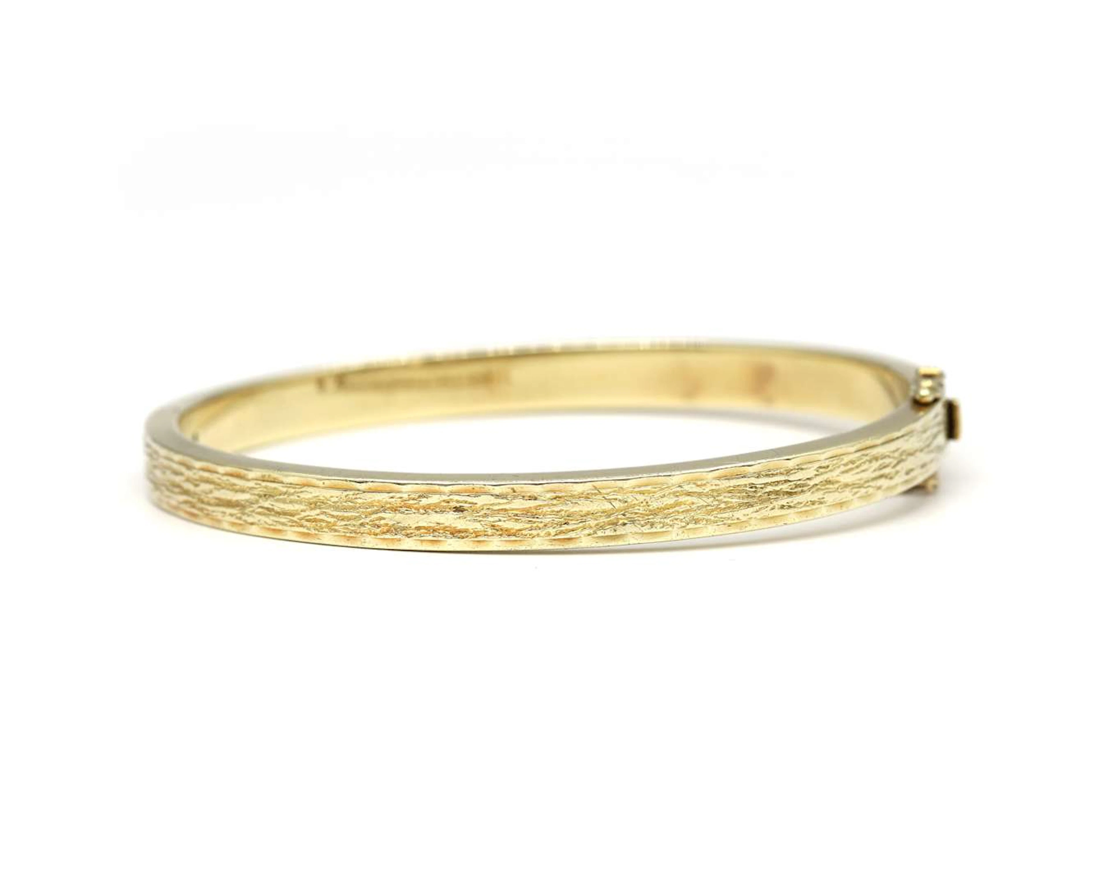A 14k yellow gold bangle bracelet