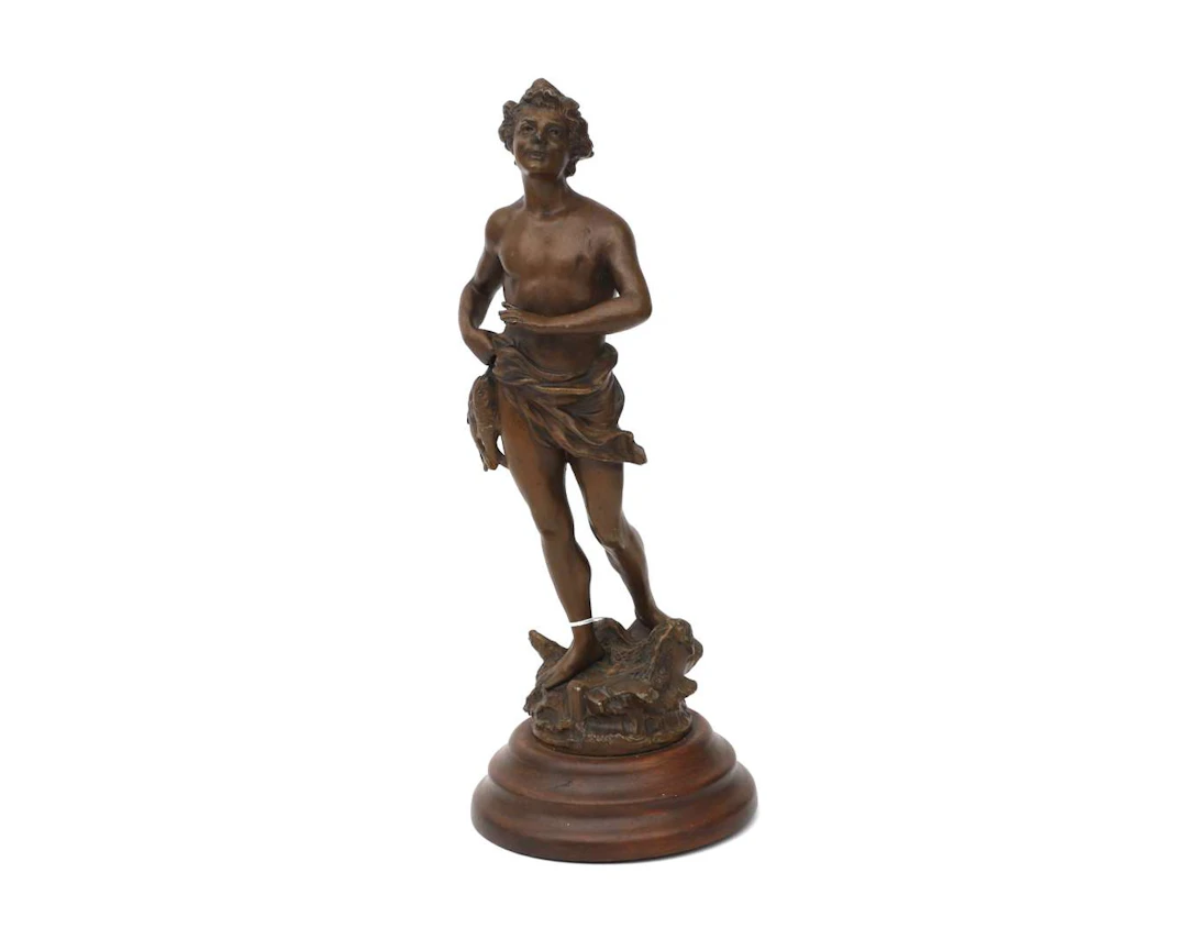 A bronze-coloured metal statue of a fisherman, 20th century