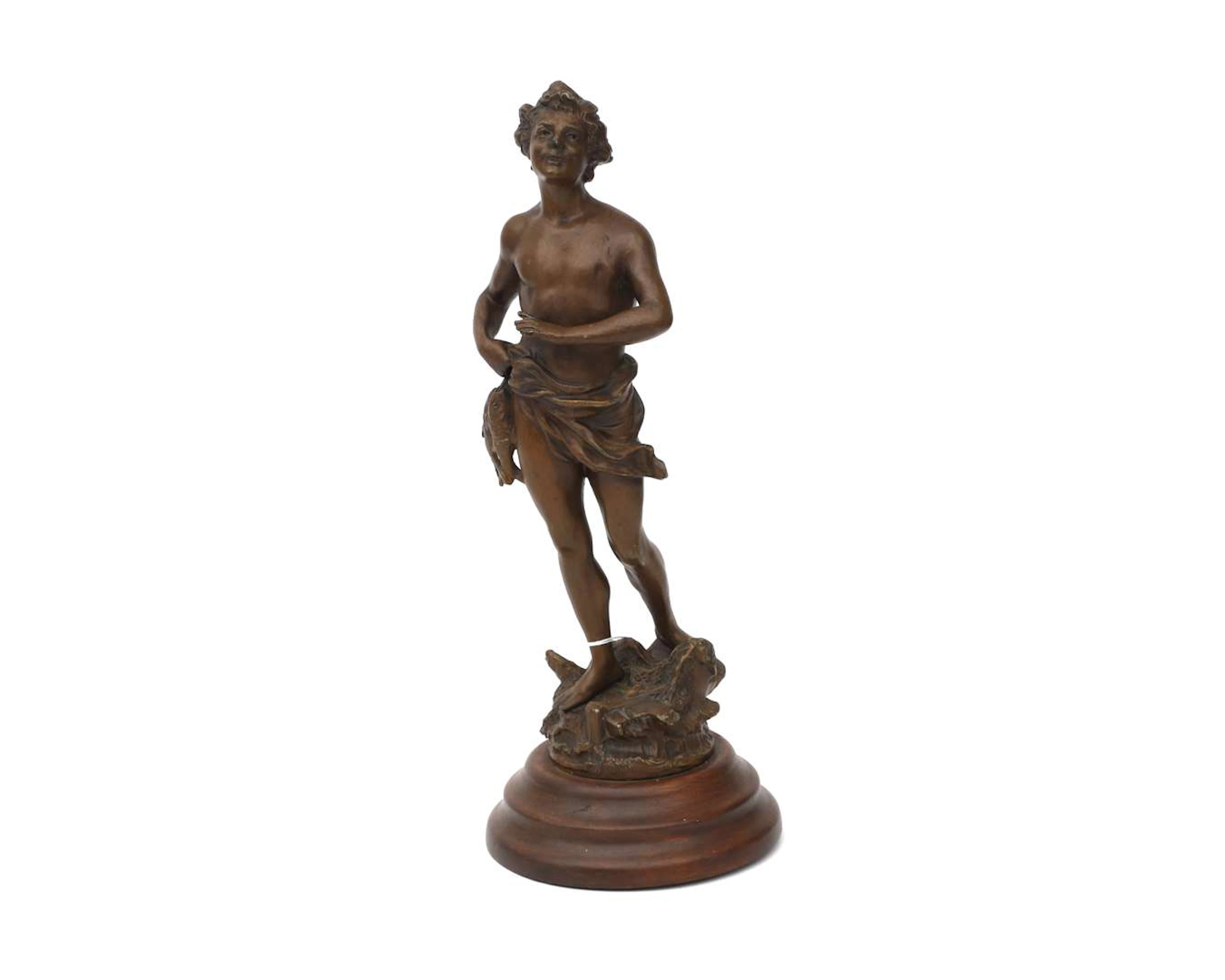 A bronze-coloured metal statue of a fisherman, 20th century