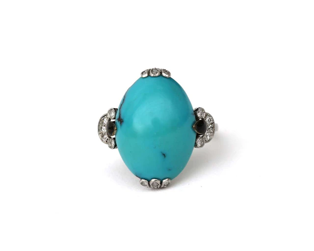 A platinum Art Deco ring with black enamel, turquoise and diamonds