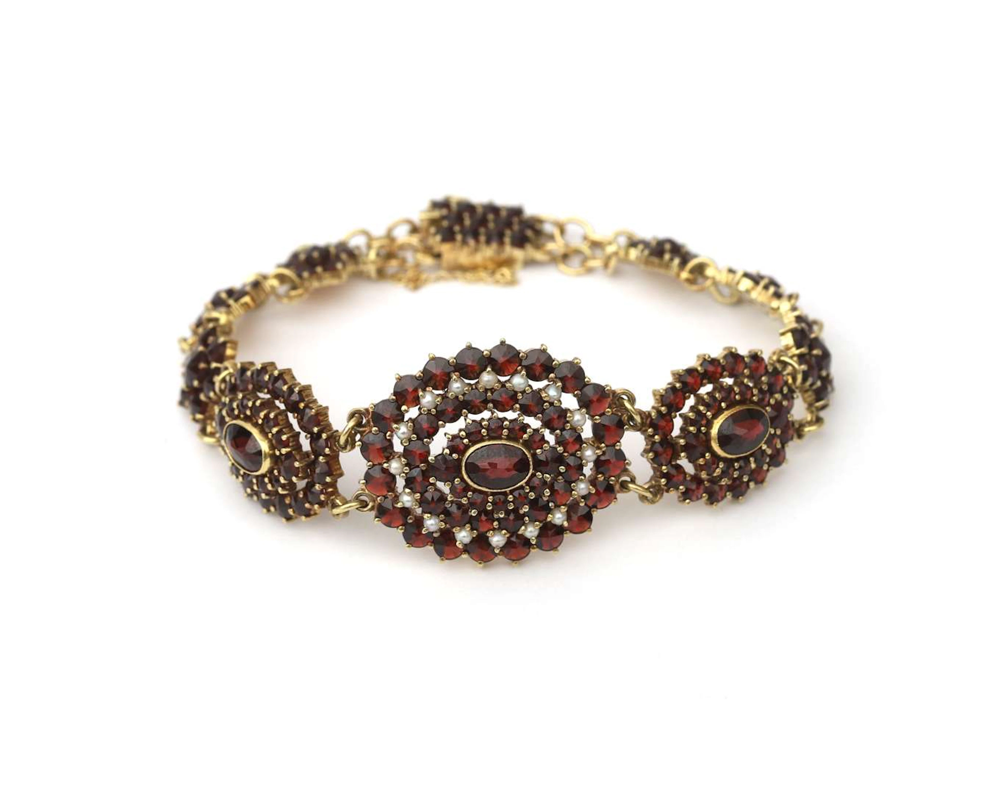A 14-carat yellow gold bracelet with garnet and seed pearls