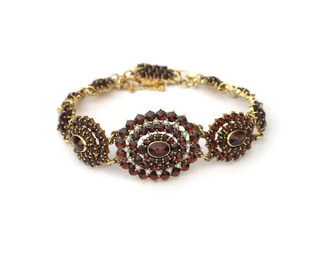A 14-carat yellow gold bracelet with garnet and seed pearls