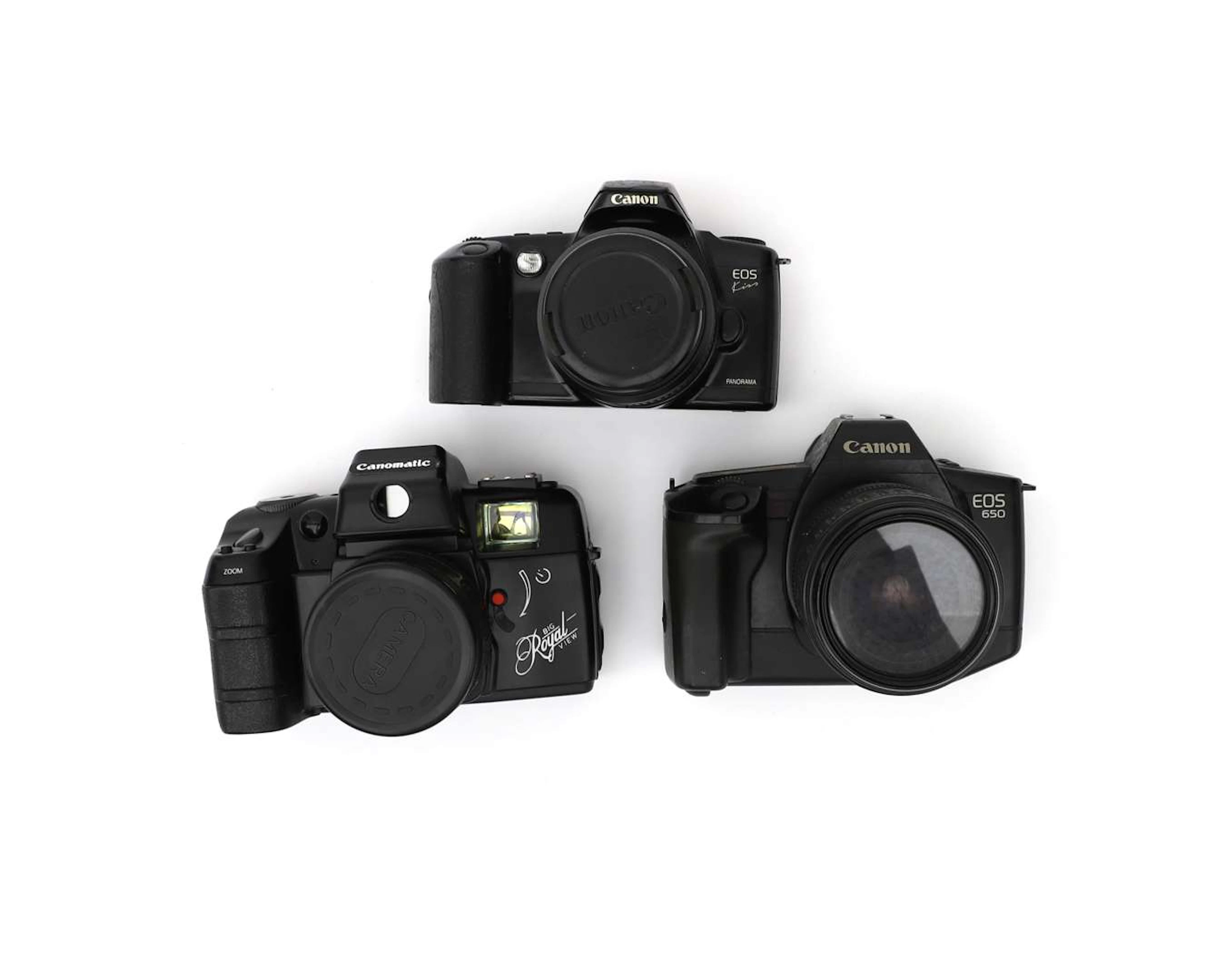 Three Canon 35mm cameras with lenses