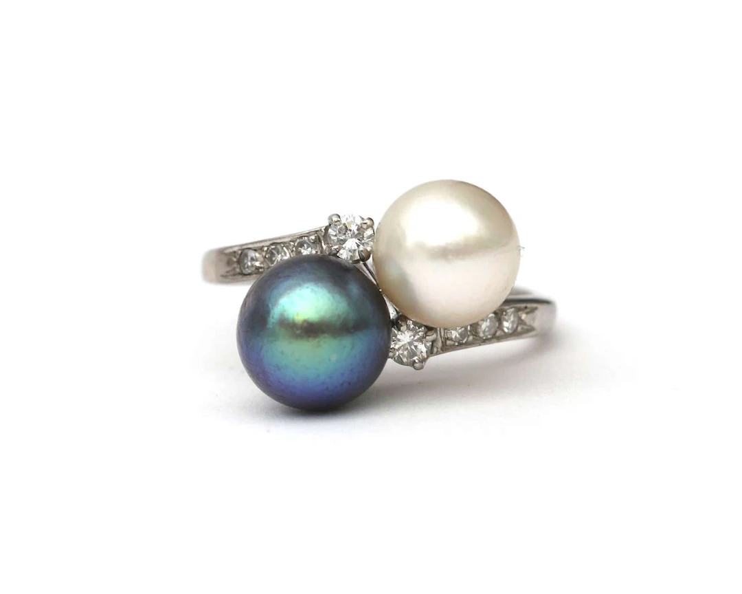 A 14k white gold ring with cultured pearls and diamonds