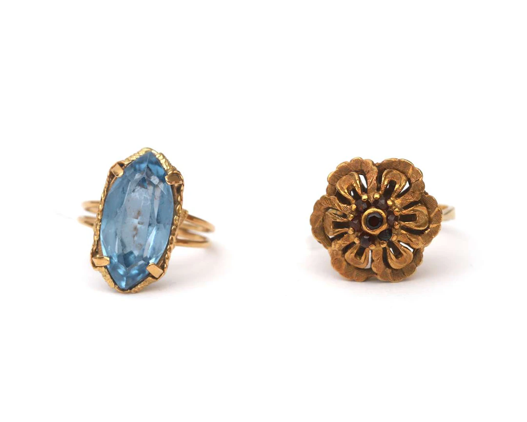 A set comprising two 14k yellow gold rings with gemstones