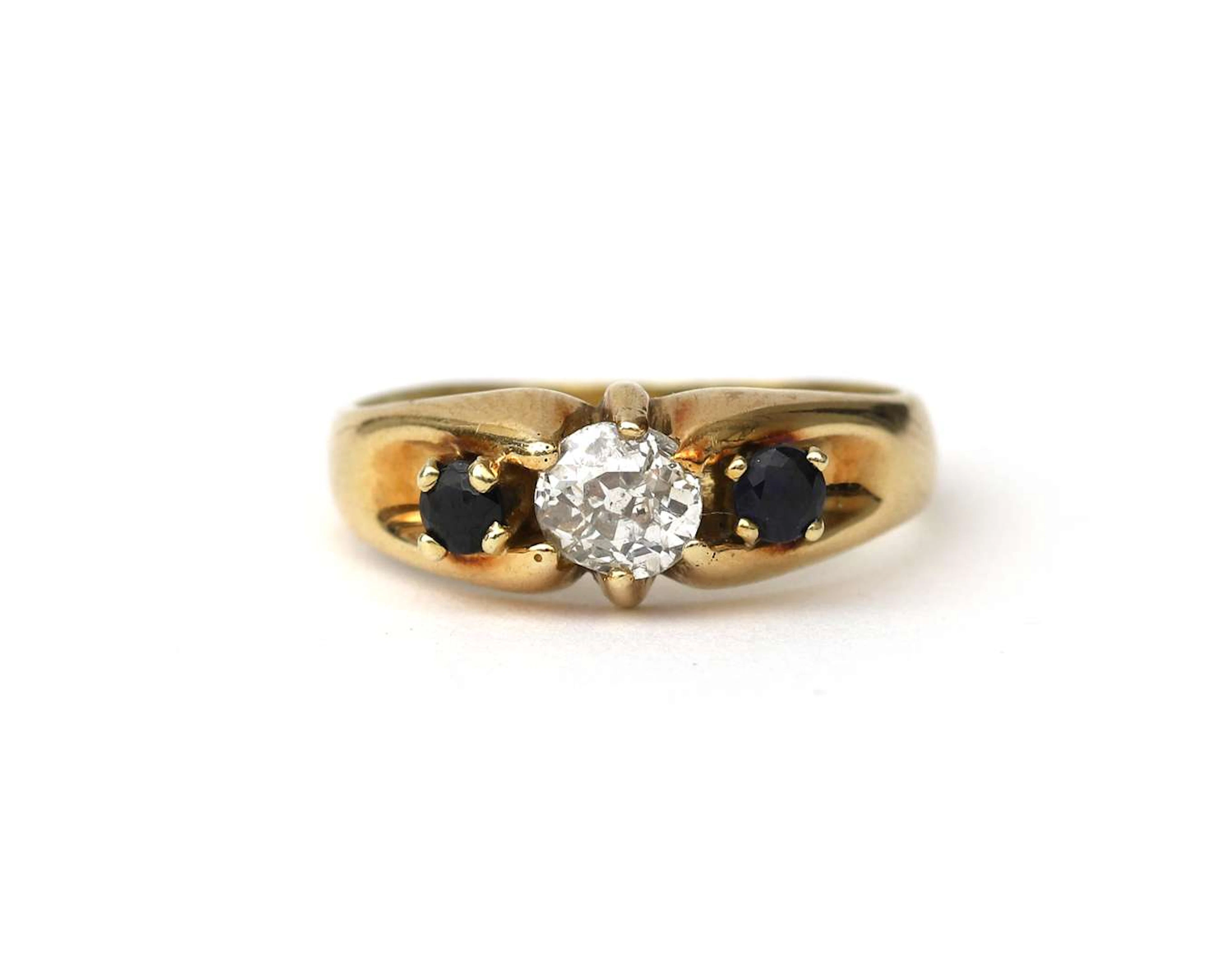 A 14-carat yellow gold ring with a diamond and a sapphire