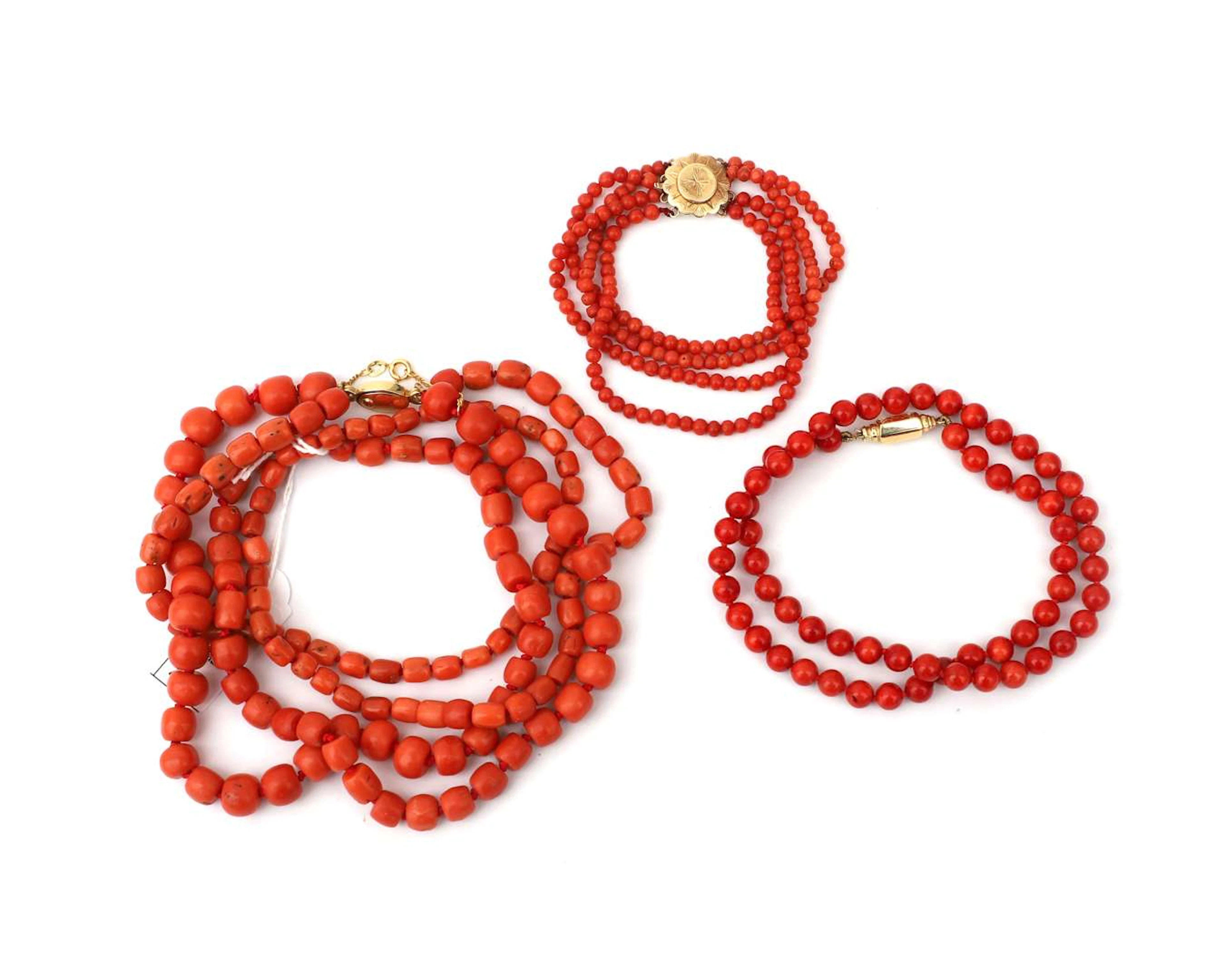 A lot comprising coral necklaces and a bracelet with 14k yellow gold clasps