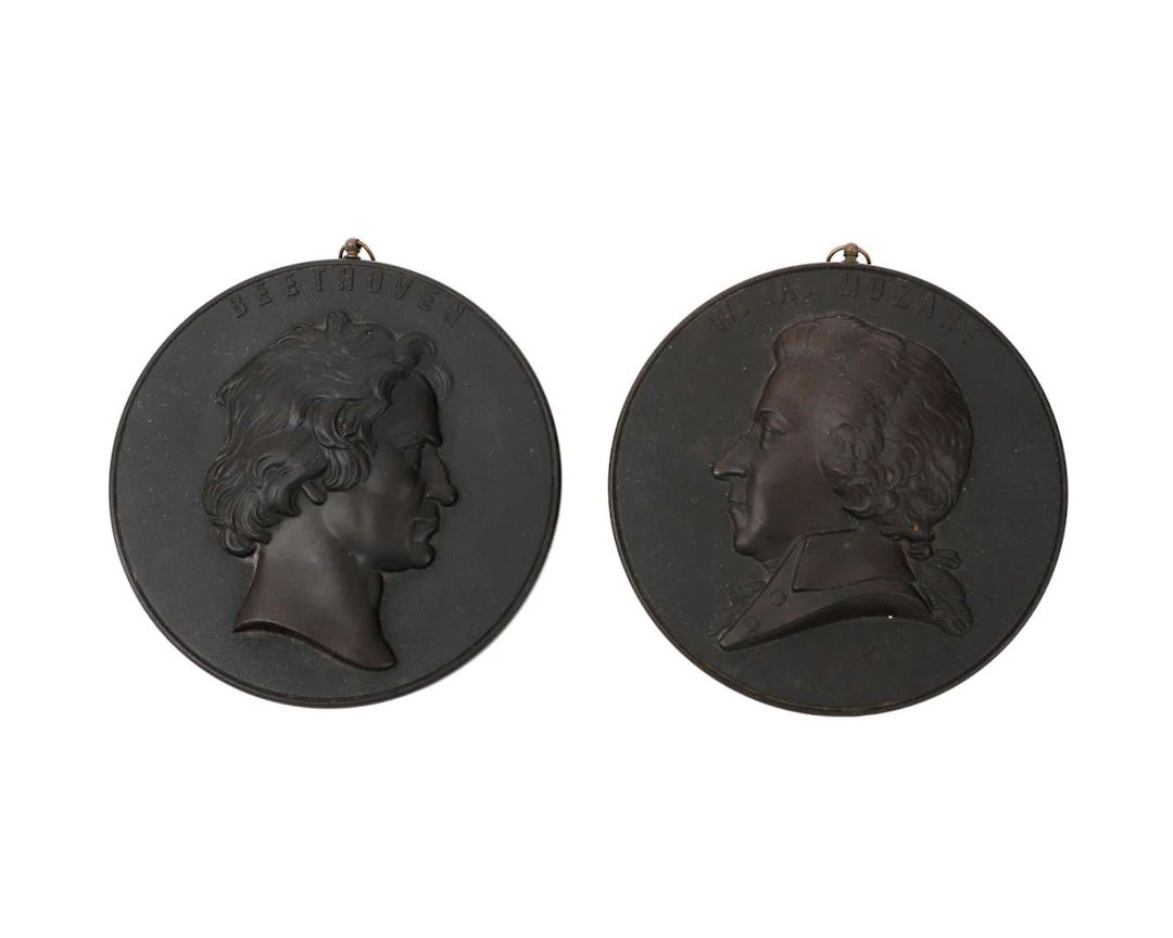 Two hard-wood portrait medallions, ‘W.A. Mozart’ and ‘Beethoven’