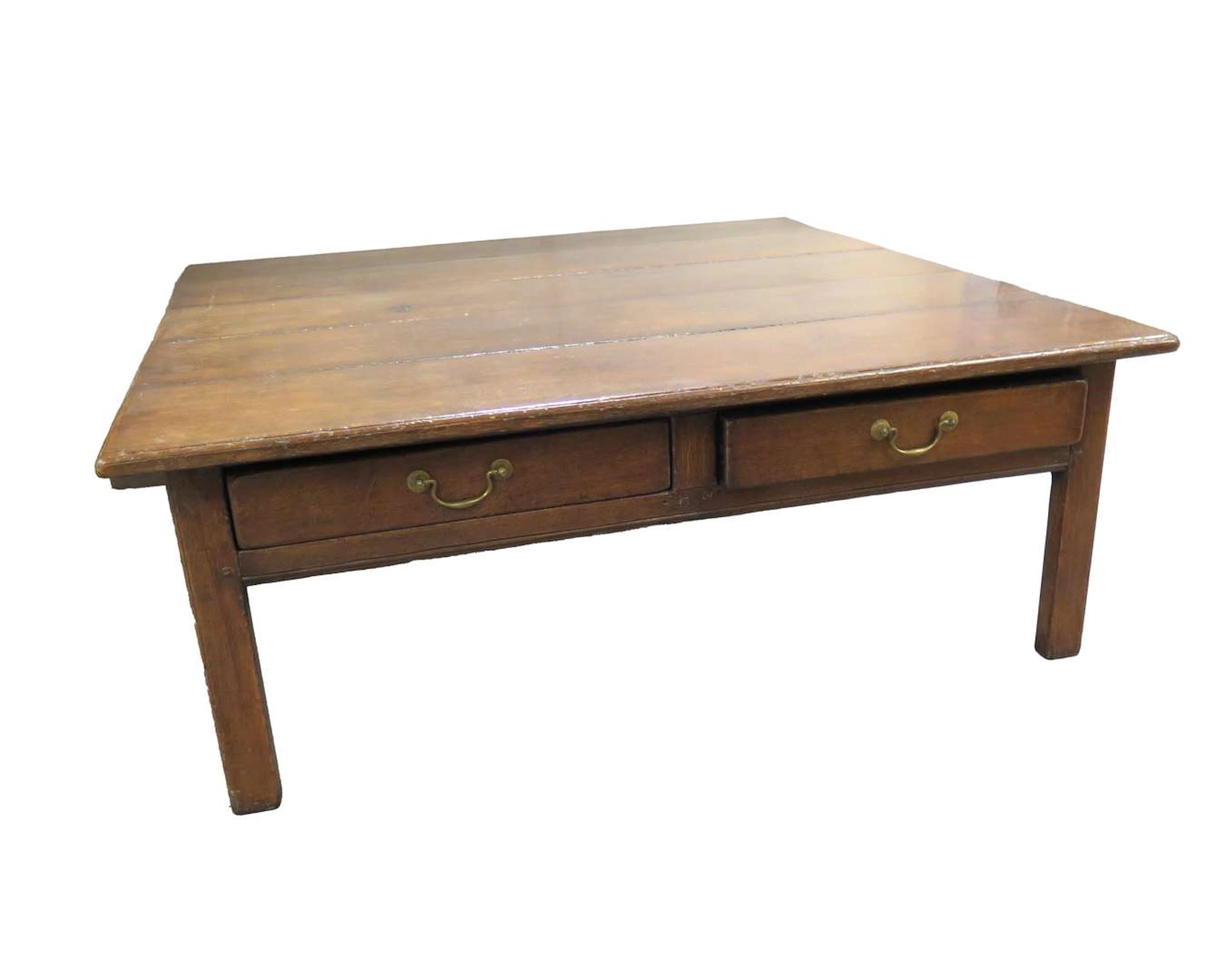 A low, square oak table with four drawers