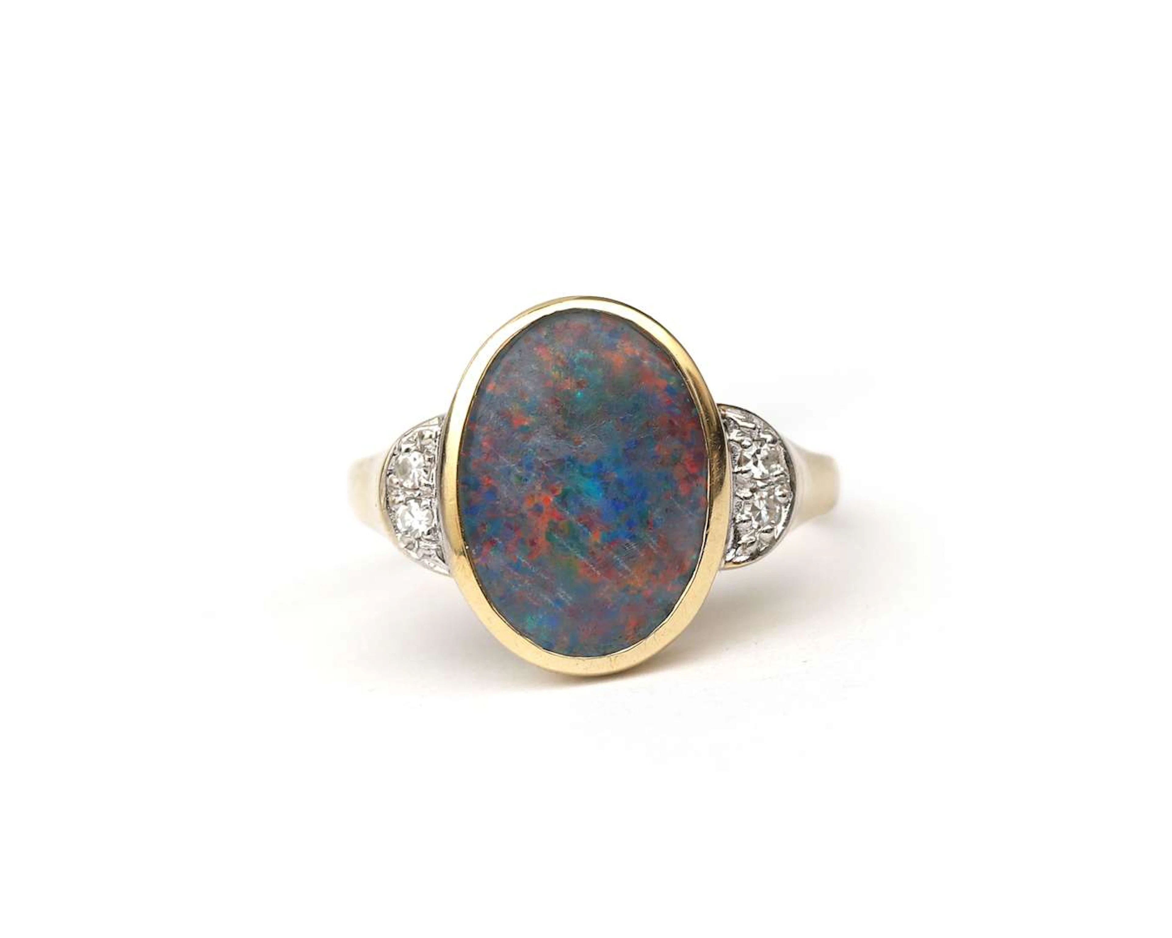 A 14k yellow gold ring with an opal triplet and a diamond