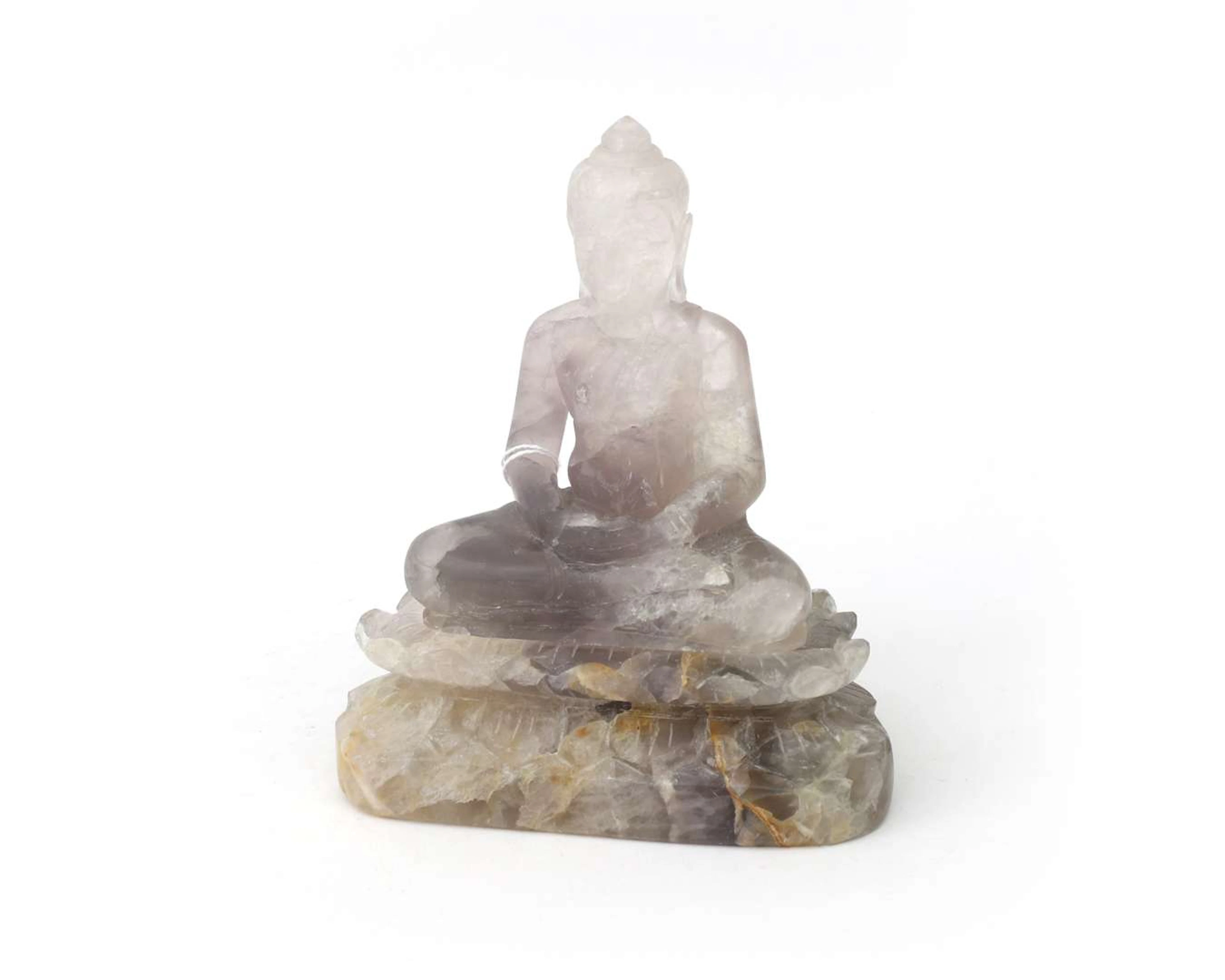 A rock crystal sculpture. Seated Buddha on a single lotus flower.