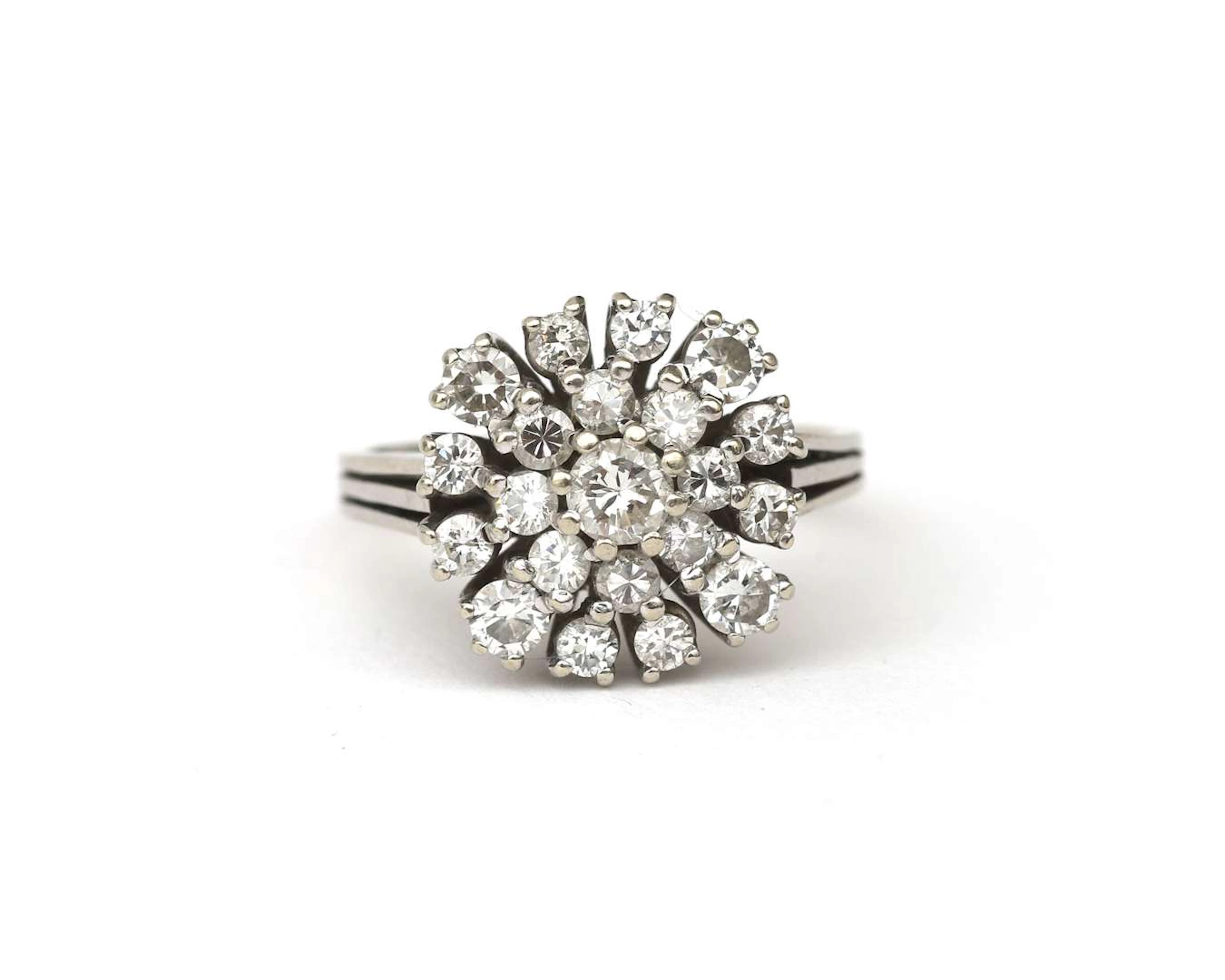 An 18-carat white gold rosette ring set with a diamond