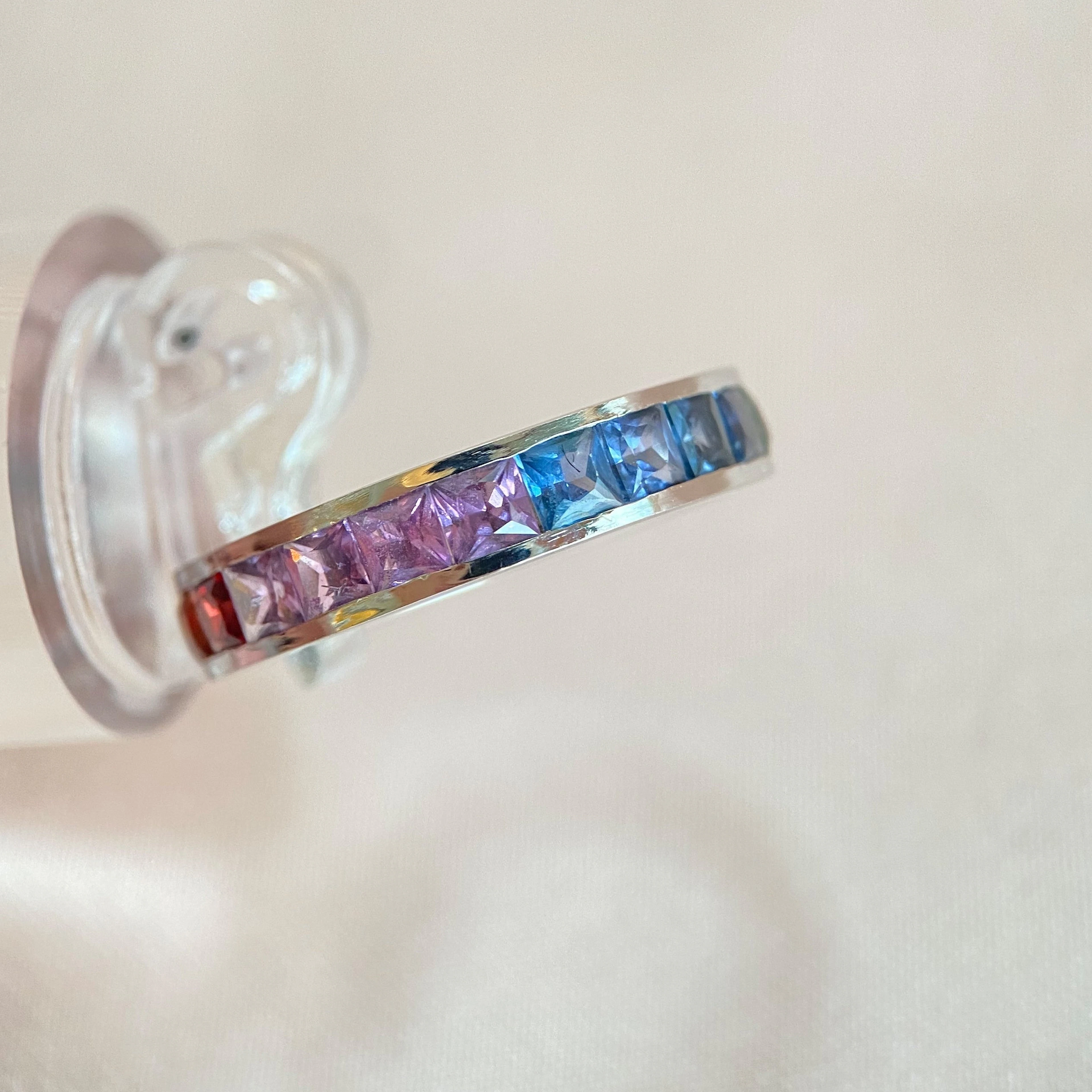 Modern white gold ring with princess-cut colored sapphires