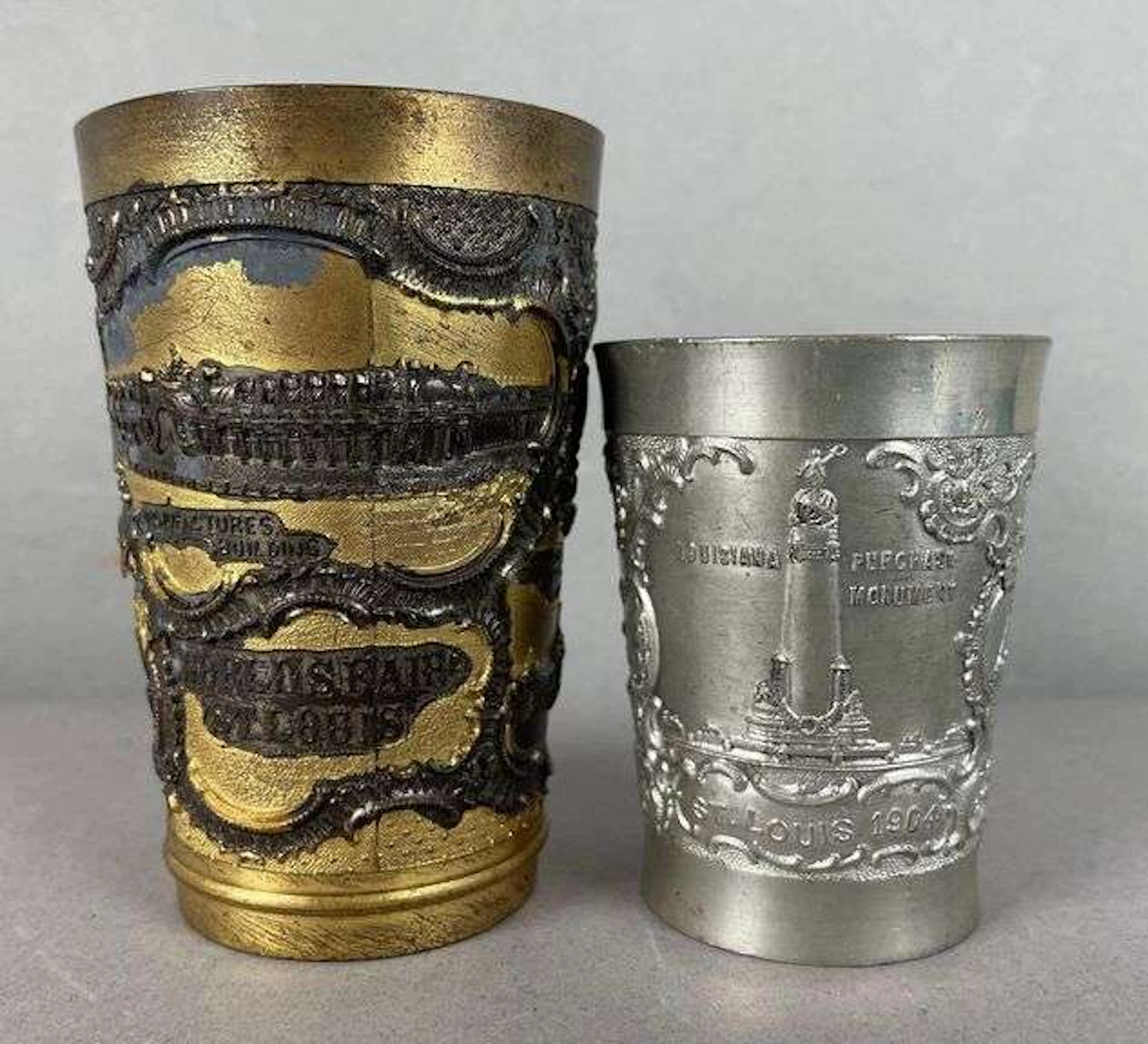 Group of 2 1904 St. Louis Worlds Fair Embossed Metal Cups