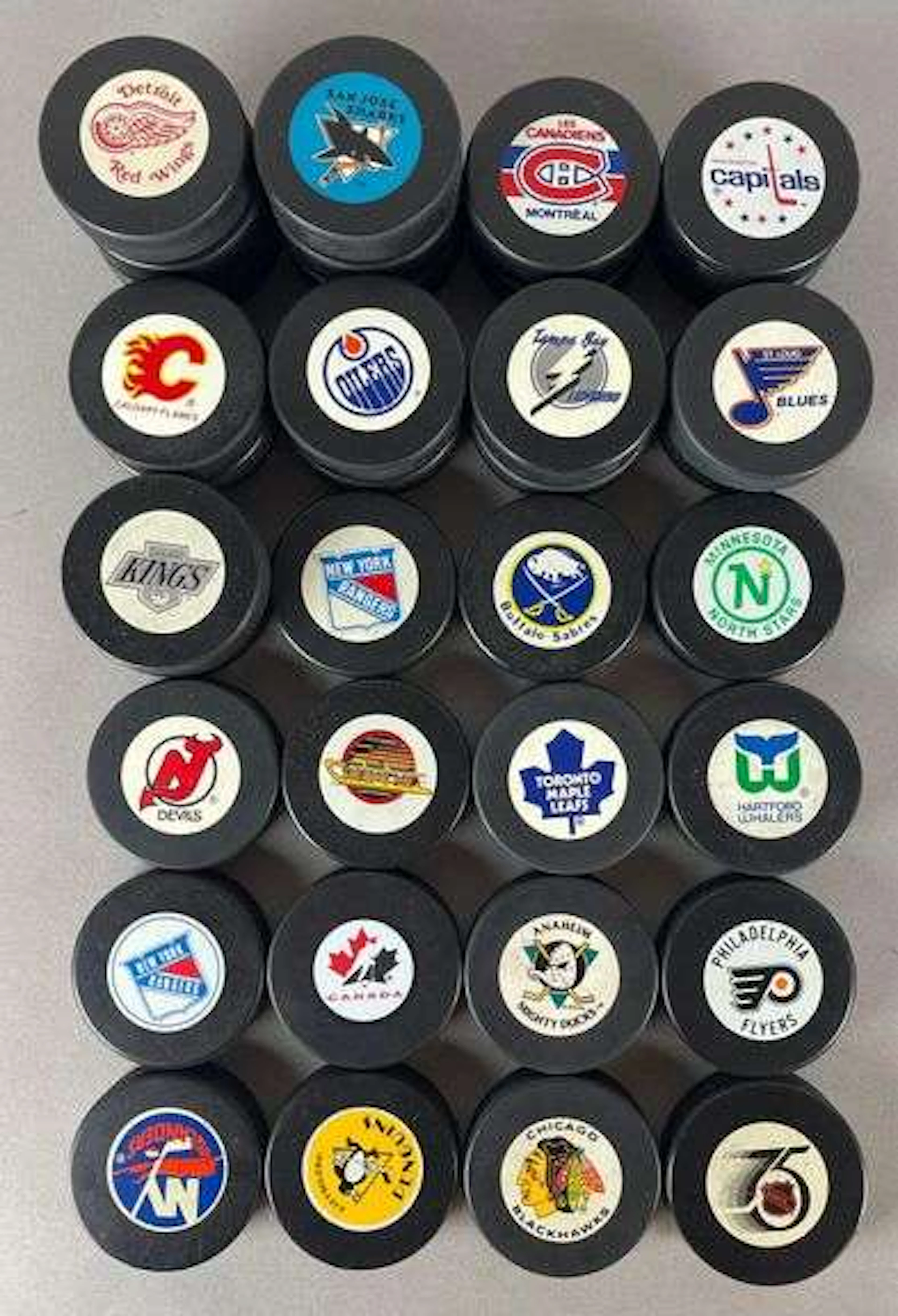 35 - NHL Team Hockey Pucks