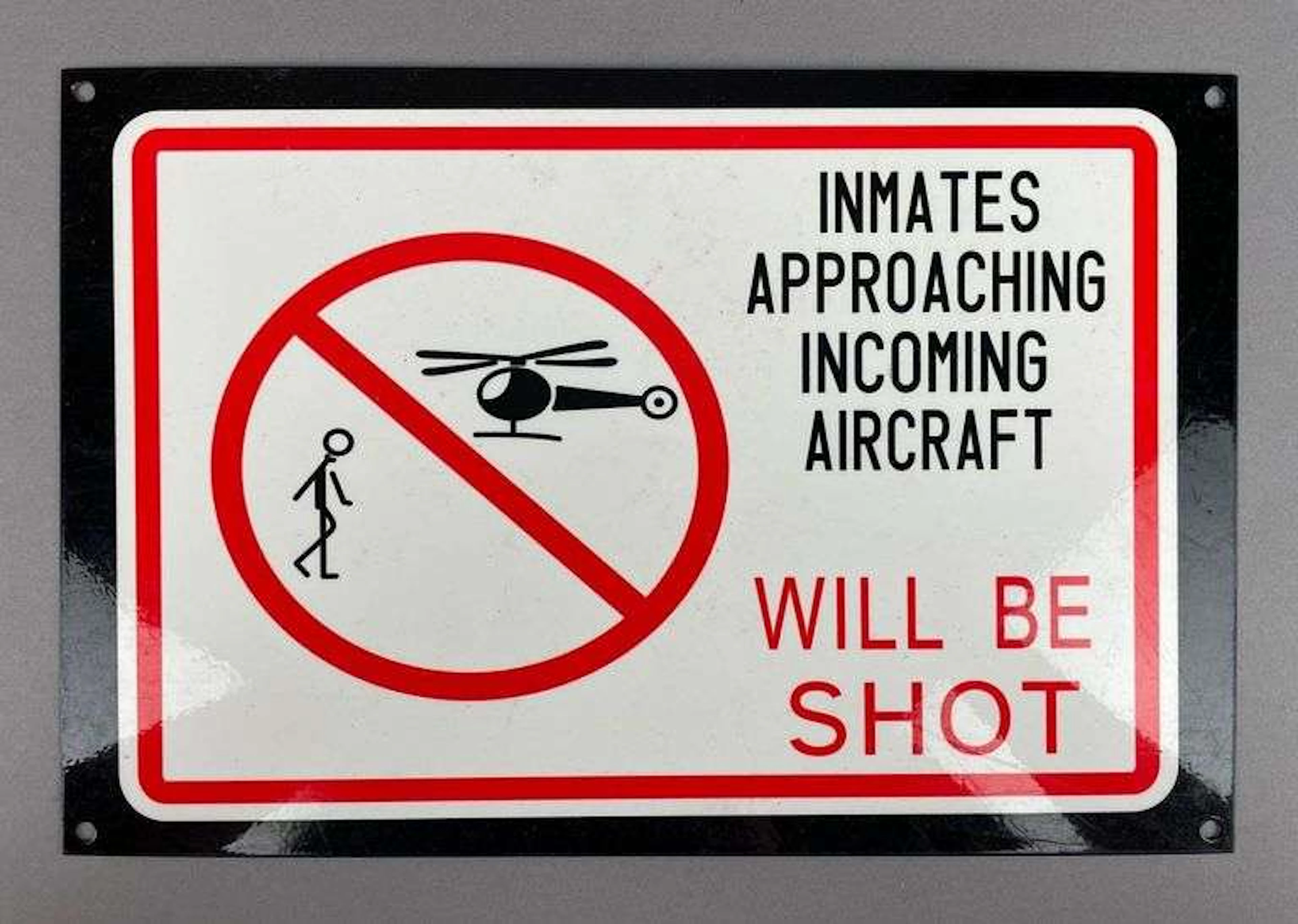 Inmates Approaching Incoming Aircraft Will be Shot Porcelain Sign