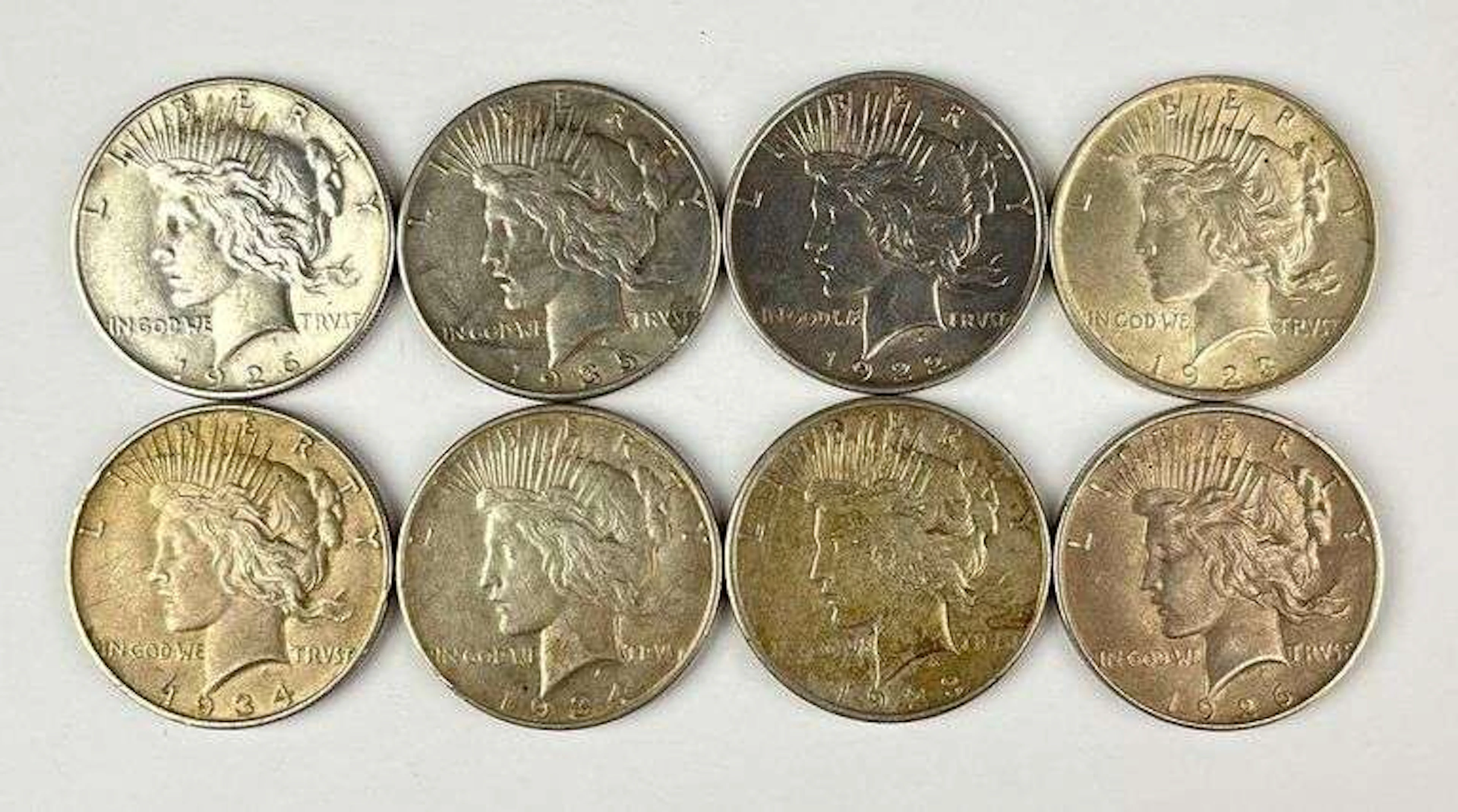 Group of 8 US Peace Silver Dollars