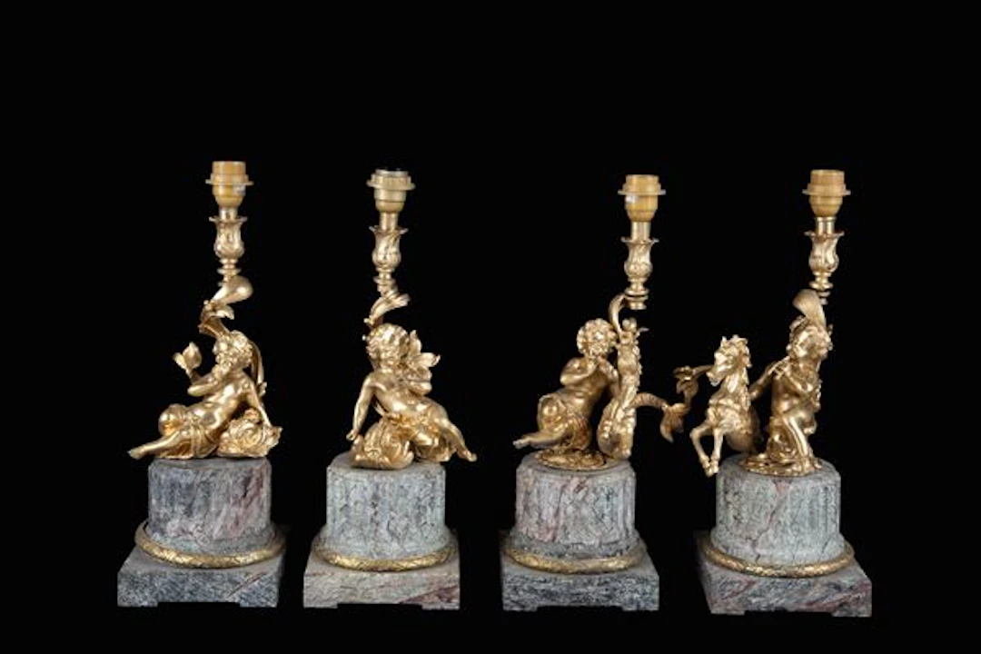 Quattro candelieri con putti