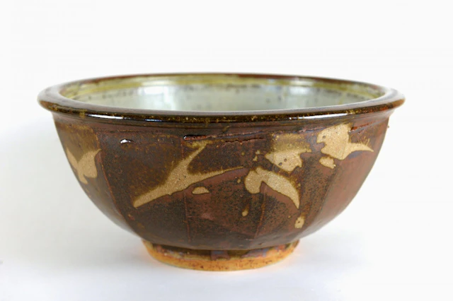 Cut sided bowl, wax resist, kaki and ash glaze by Jim Malone