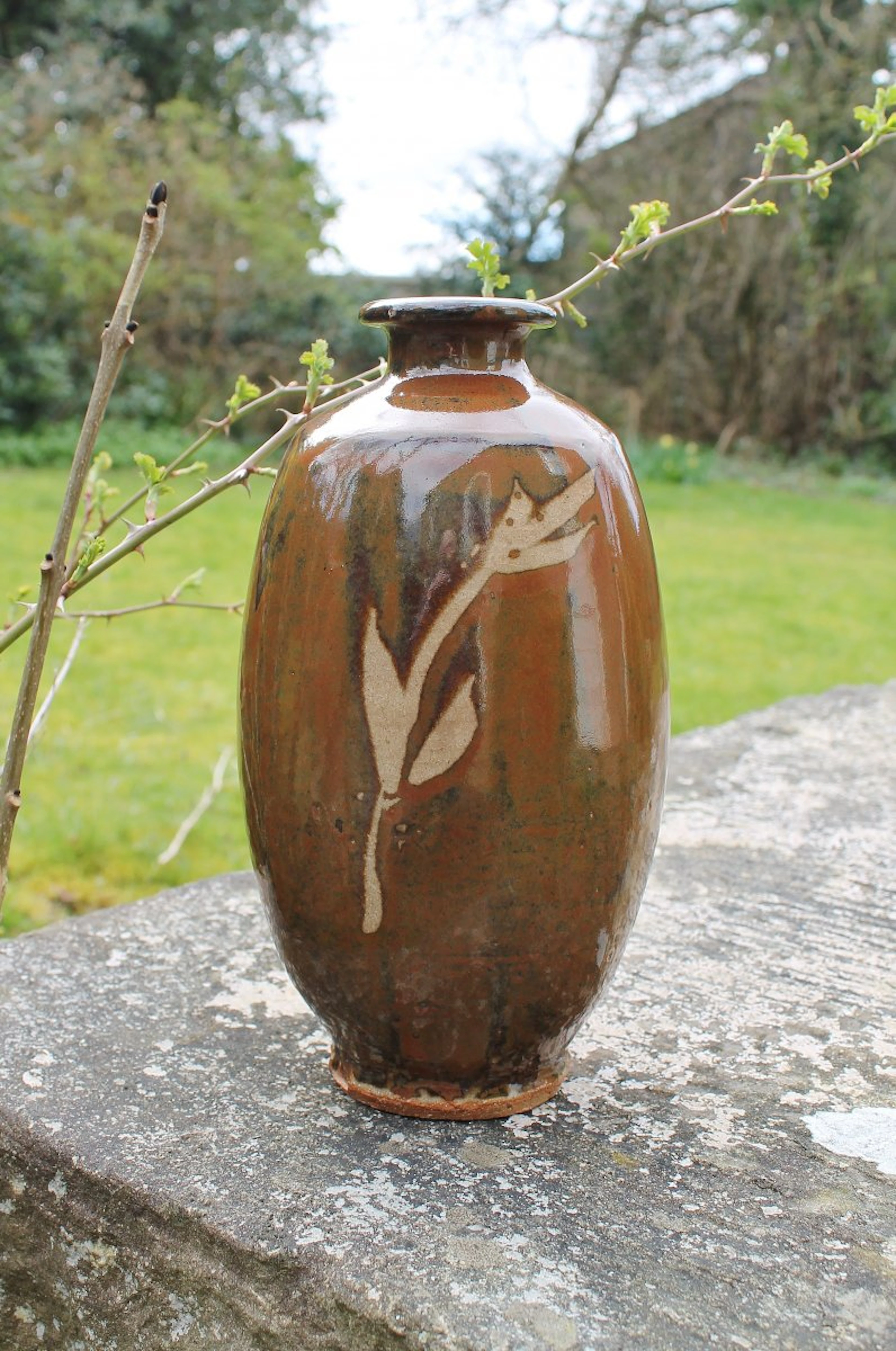 Footed bottle, paddled flat, wax resist and kaki glaze by Jim Malone