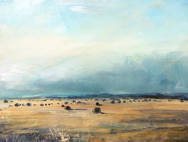 Hay bales under heavy cloud by Sarah Carrington