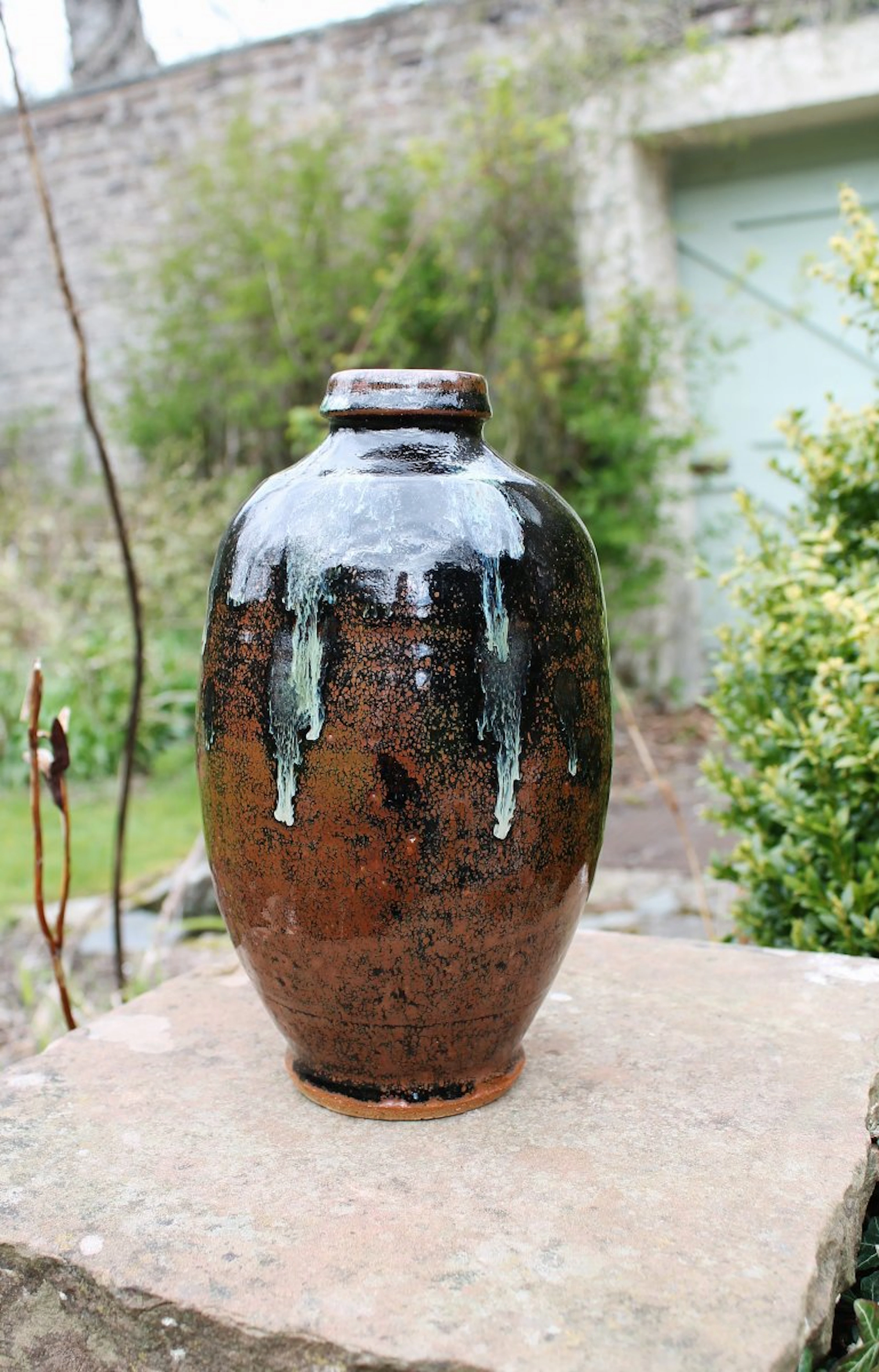 Footed bottle, tenmoku, copper glaze pours by Jim Malone