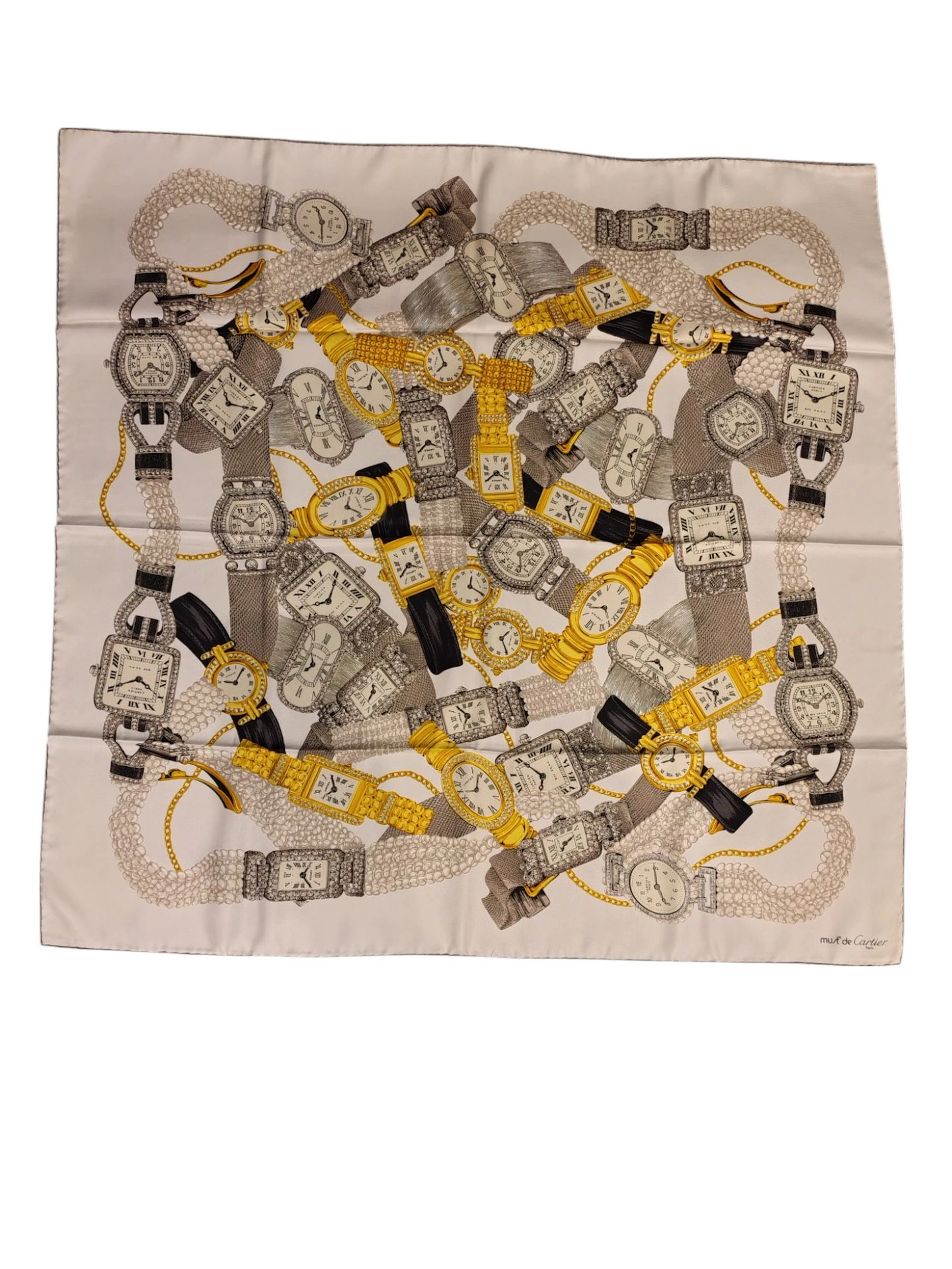 CARTIER Must de Carré en twill de soie à décor de montres de la maison Bon état, quelques traces Dans sa boite avec la carte d'authenticité