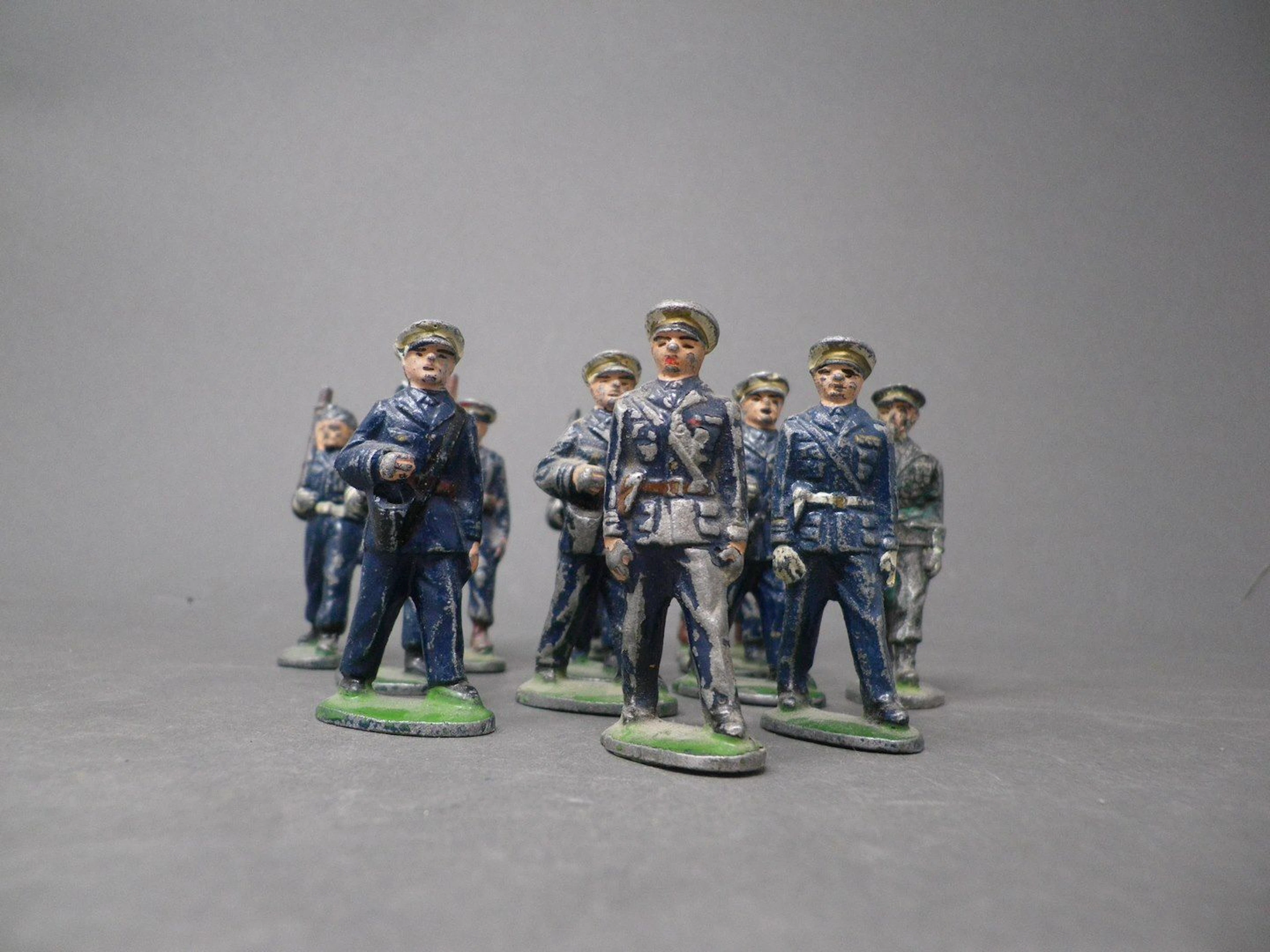 QUIRALU - Aviateurs au défilé (1952-1960) Treize figurines en battle-dress bleu avec casquette blanche ou en calot, dont : soldats arme sur l'épaule ou mitraillette à la hanche, reproduits p. 116 - Bibliographie : Les jouets Quiralu 1933-1964 - R. Alazet - J. Borsarello - H. Giroud - Ed° J. Granchet Paris. Jouets anciens pouvant présenter des manques de peinture, des chocs ou des manques, y compris pour les conditionnements éventuels. Vendus en l'état et sans réclamations.