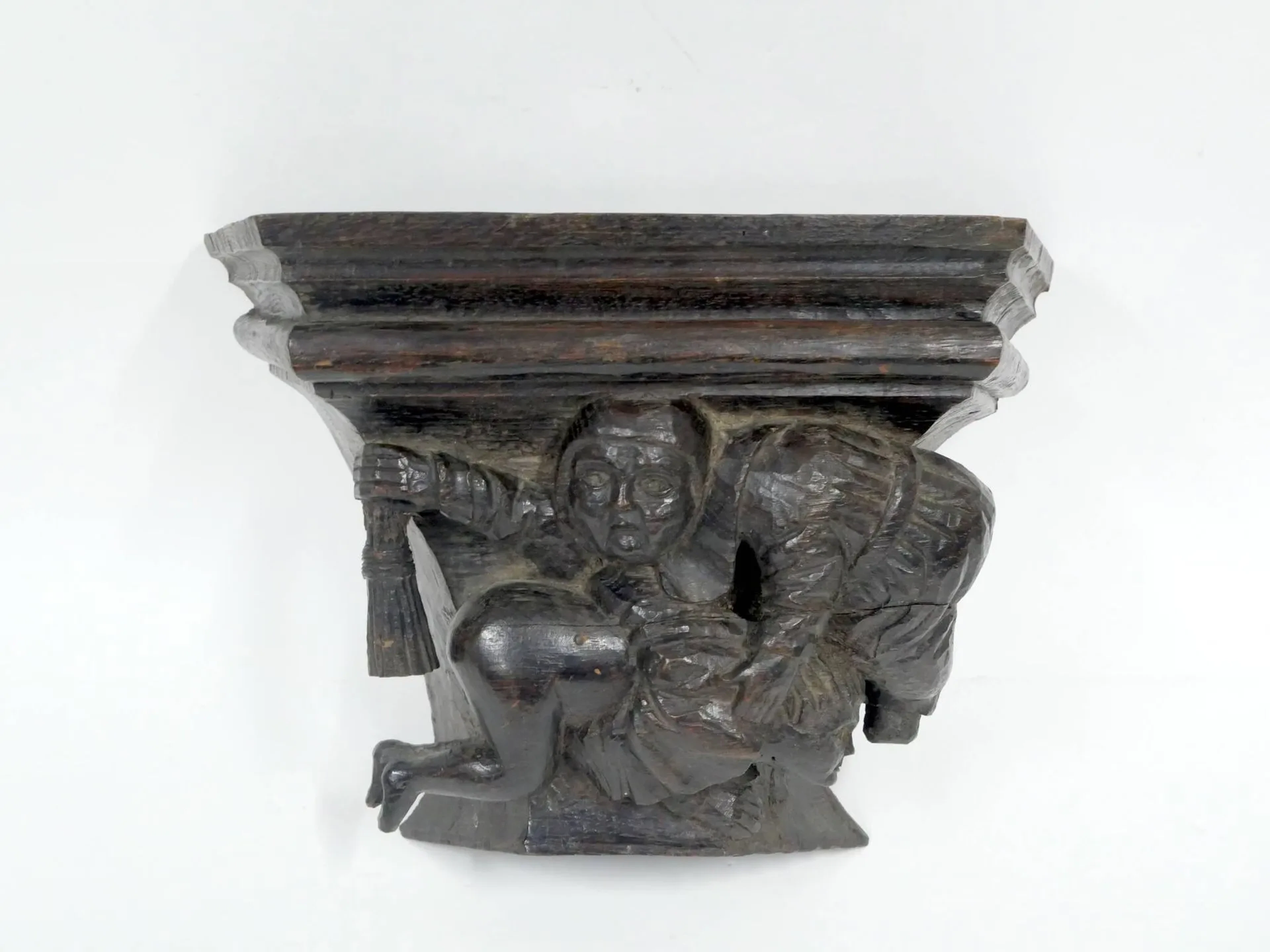 A carved wooden wall-mounted seat in the medieval style, fea - Lot 273