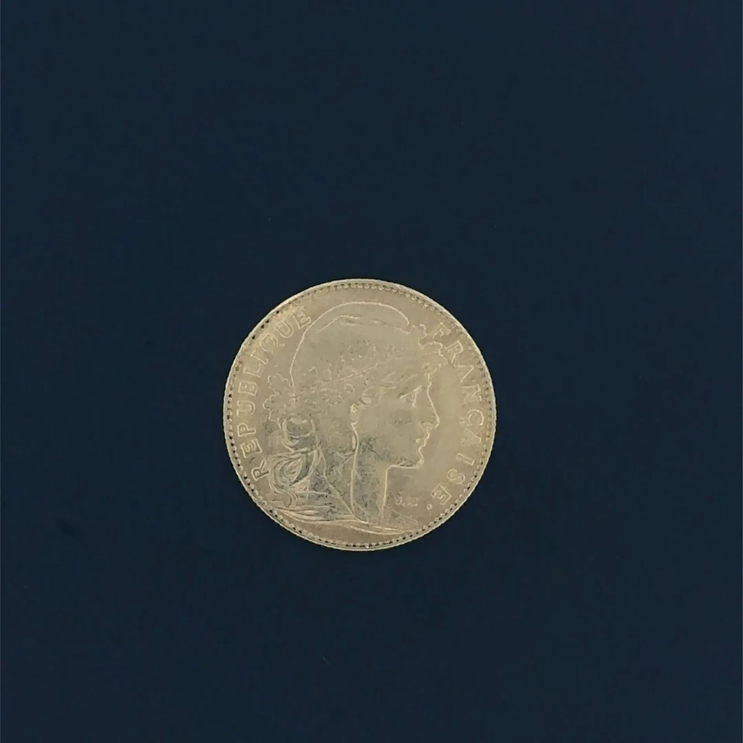 A 1900 10-franc gold "Rooster" coin. Shows signs of setting - Lot 21