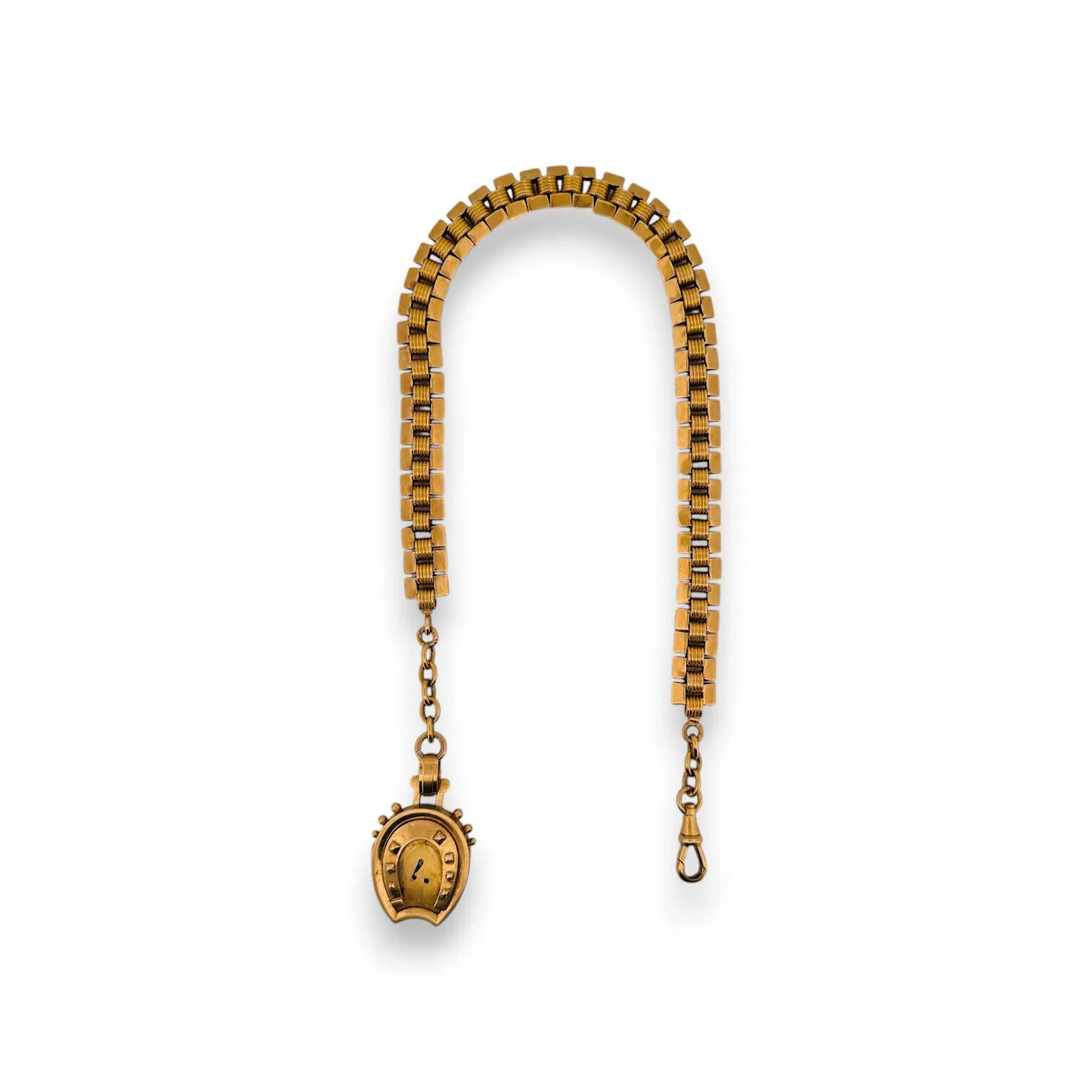 Yellow gold (750) watch chain holding a yellow gold (750) so - Lot 122