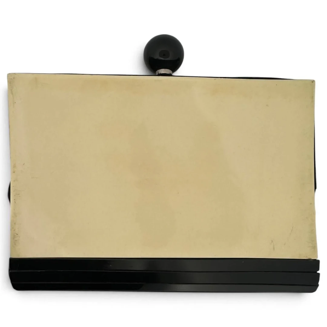 White and black resin clutch bag; the fabric-lined interior - Lot 211