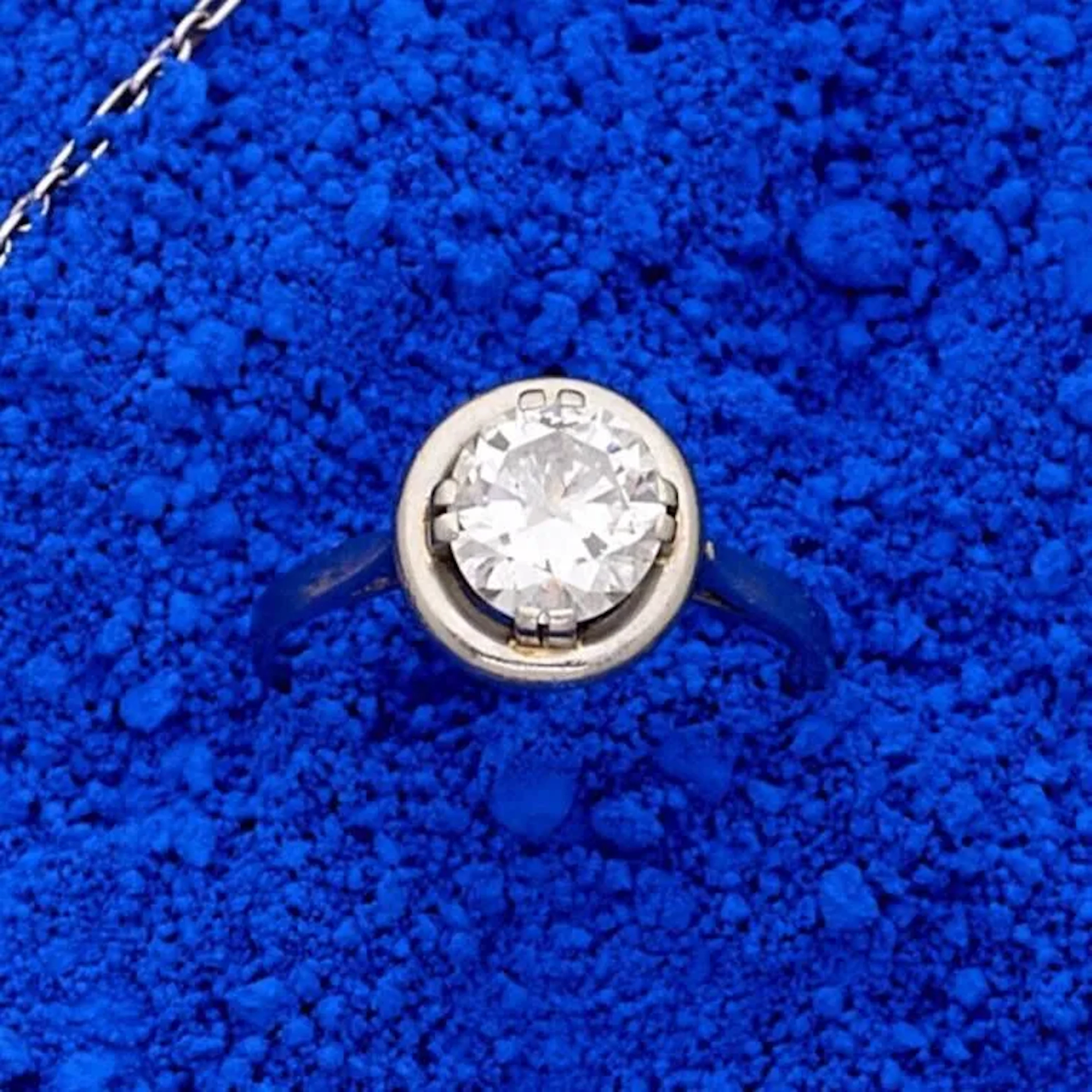 Bague solitaire en platine (850e), ornée d'un diamant demi-taille en double serti griffe, entouré d'un godron, le panier à décor de volutes. Poids du diamant : 1.20 carats environ. Poids brut : 3.90 g. Tour de doigt : 55.