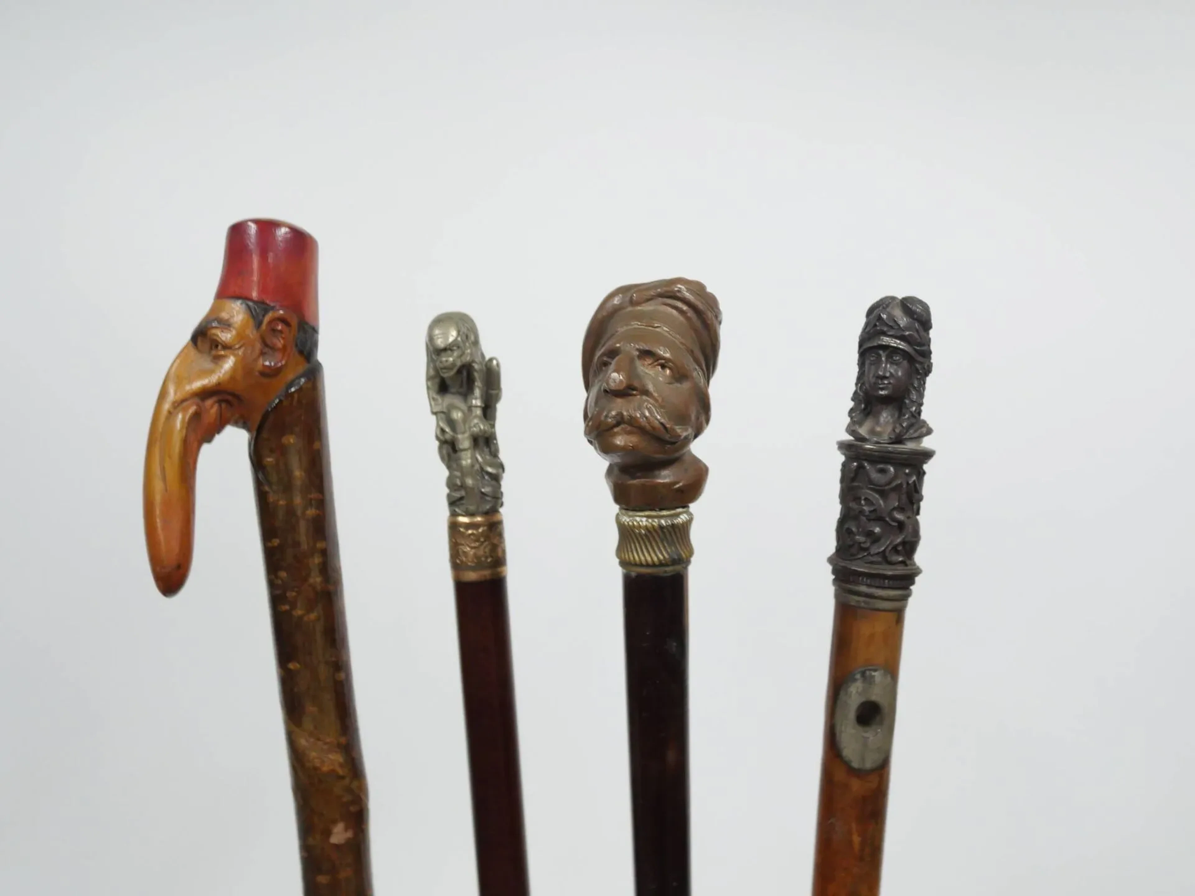 Set of four wooden canes and silver-plated or enamel cane kn - Lot 255