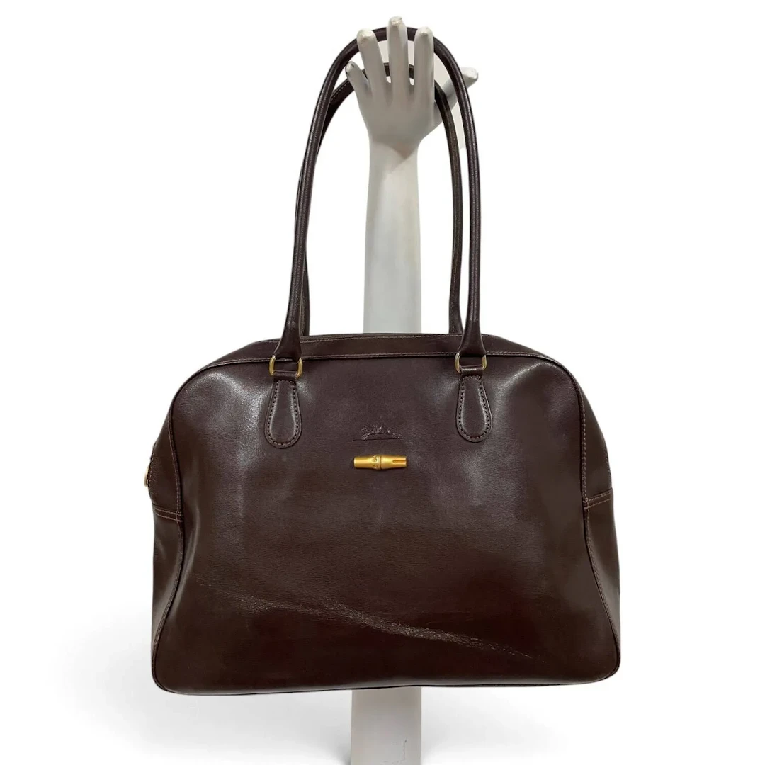 Set including a brown leather LONGCHAMP handbag, a small RAL - Lot 146