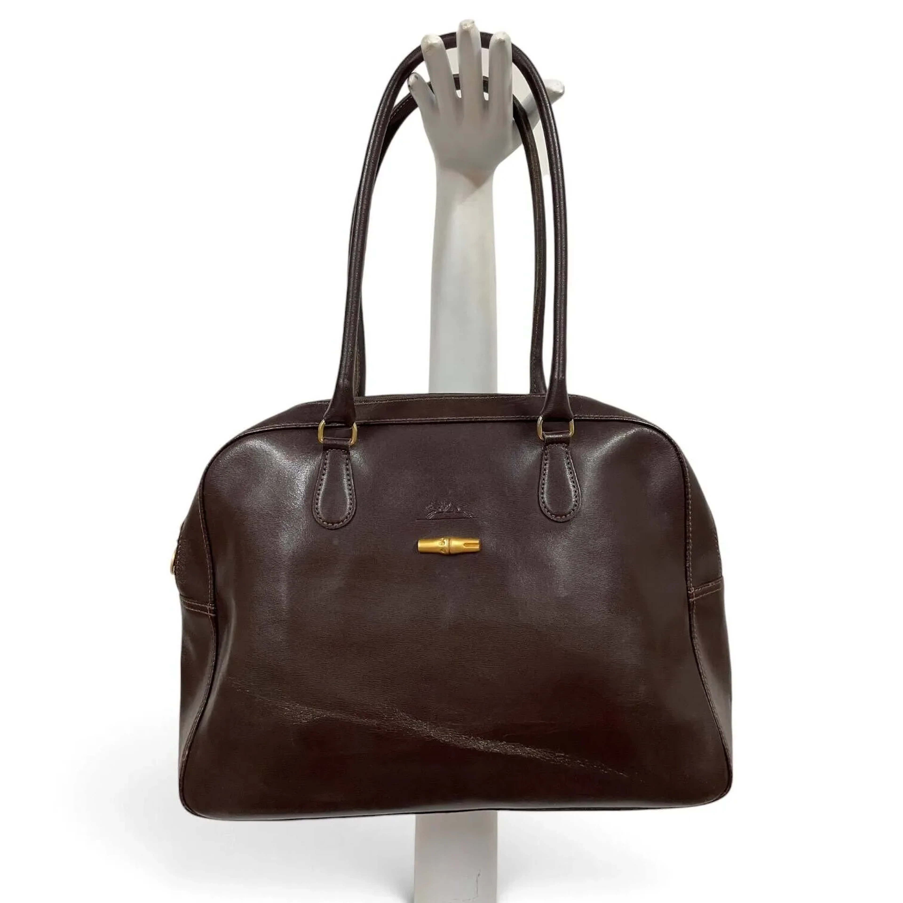 Set including a brown leather LONGCHAMP handbag, a small RAL - Lot 146