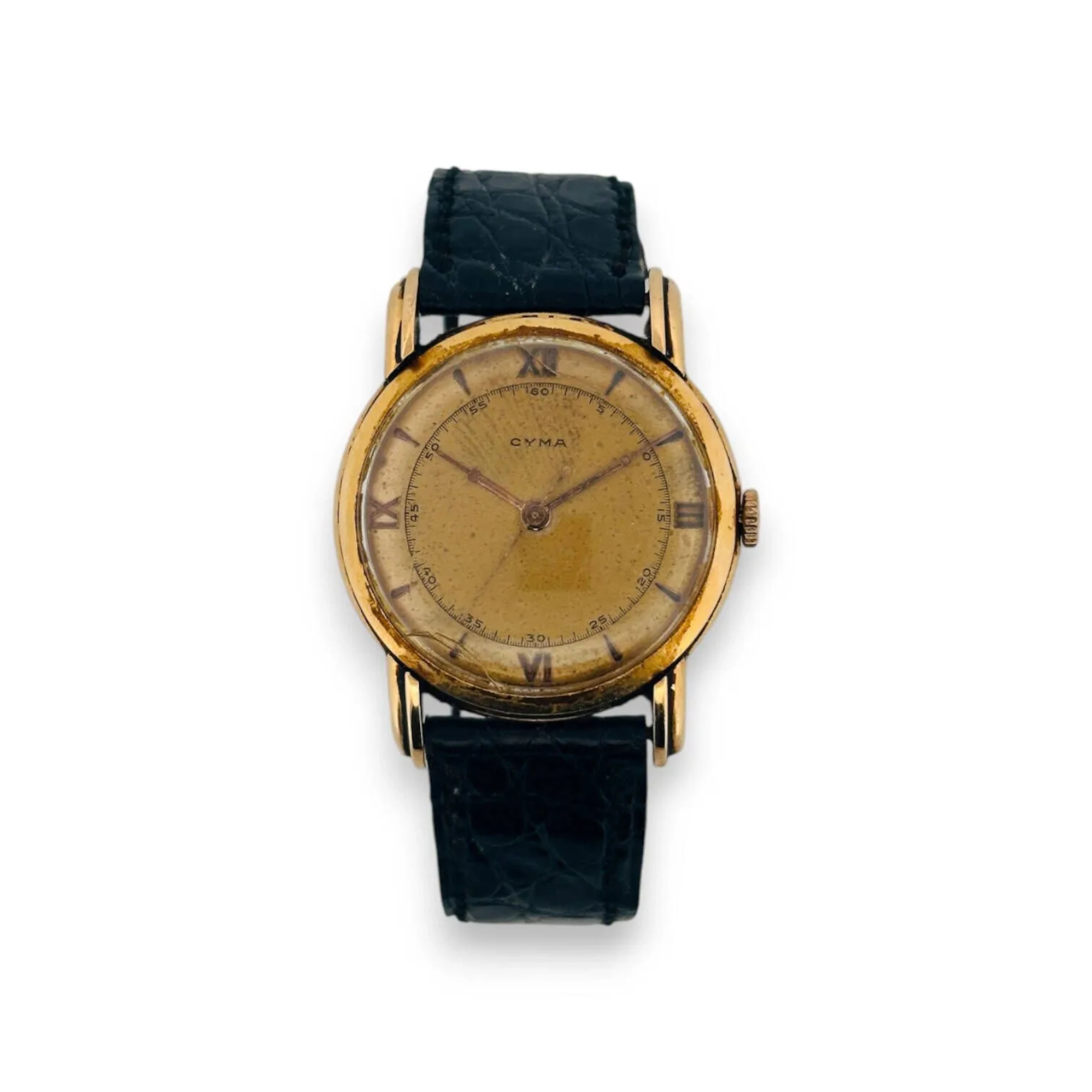CYMA Montre bracelet pour homme, boitier rond en or jaune 18K (750), cadran doré, index chiffres romains et bâtons, mouvement mécanique, bracelet en cuir noir (usé) à boucle ardillon en or 18K. Diam. : (chocs et rayures au verre, traces d'oxydation)