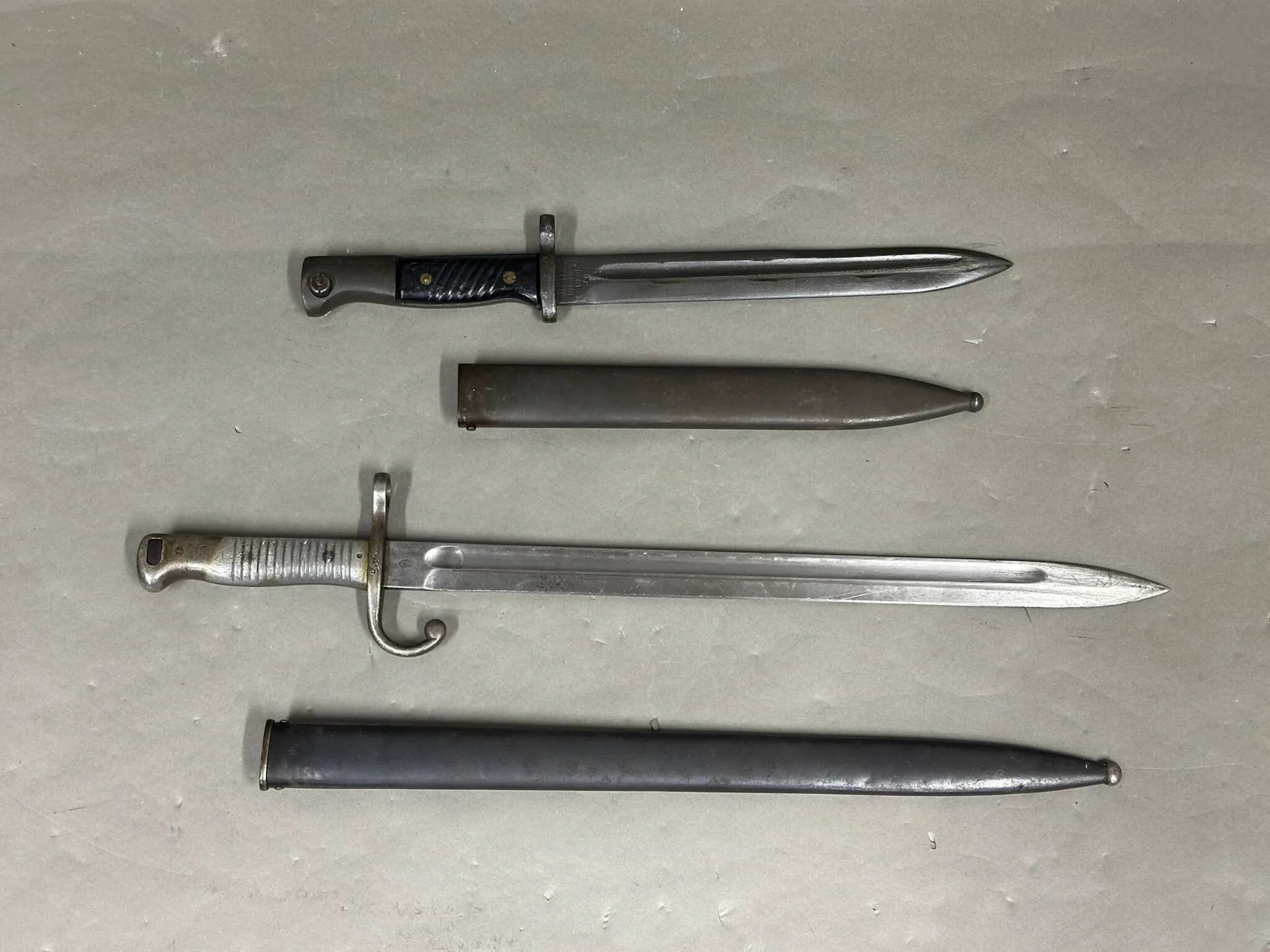 Ensemble de deux baïonnettes. Baïonnette pour l’export, fusil Mauser argentin. Baïonnette pour fusil Mauser israélien. Lame et fourreau finition phosphatée.