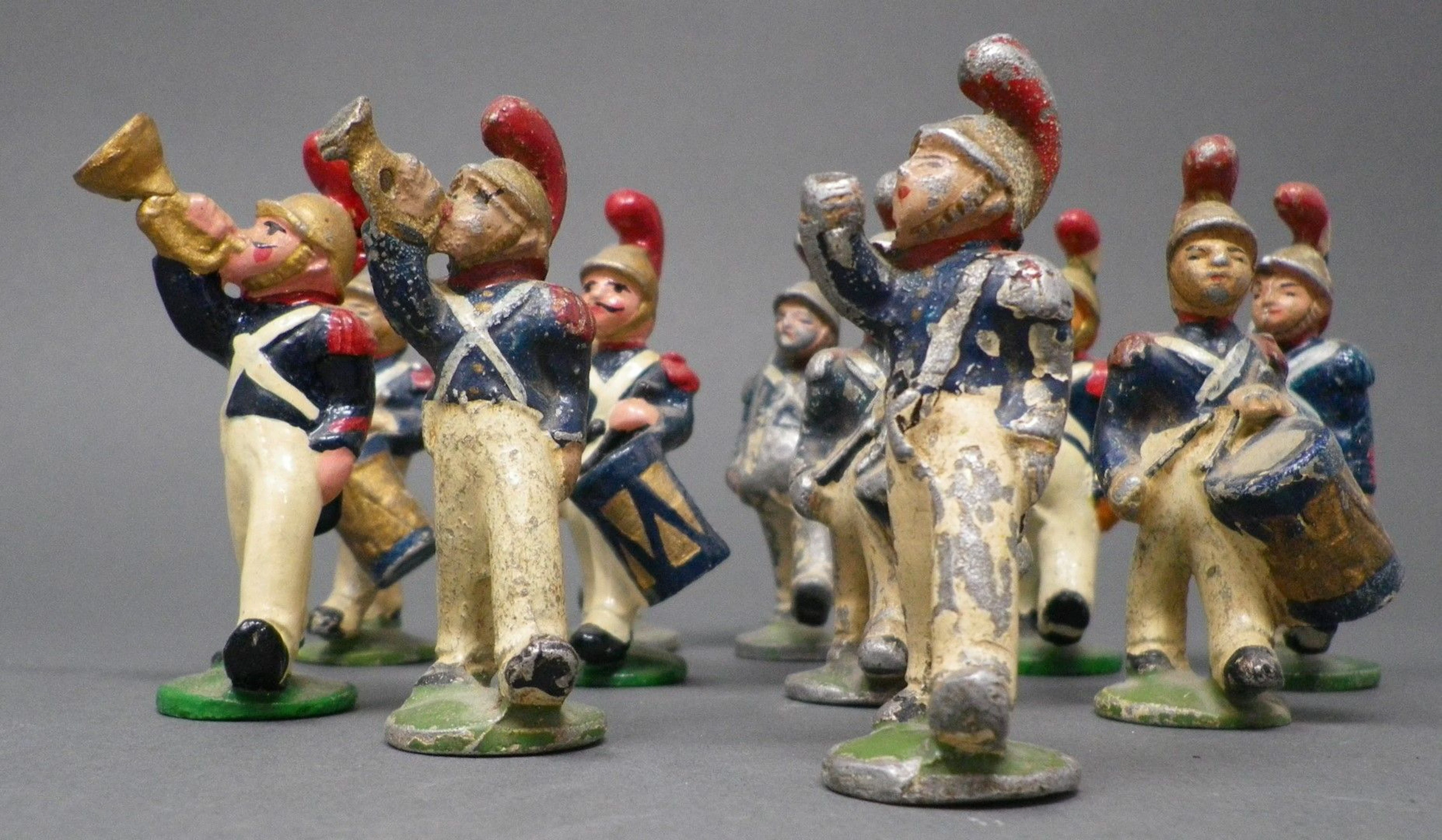 QUIRALU - Pompiers de Nanterre Douze figurines, dont : tambours, pompiers, reproduits p. 145 - Bibliographie : Les jouets Quiralu 1933-1964 - R. Alazet - J. Borsarello - H. Giroud - Ed° J. Granchet Paris. Jouets anciens pouvant présenter des manques de peinture, des chocs ou des manques, y compris pour les conditionnements éventuels. Vendus en l'état et sans réclamations.