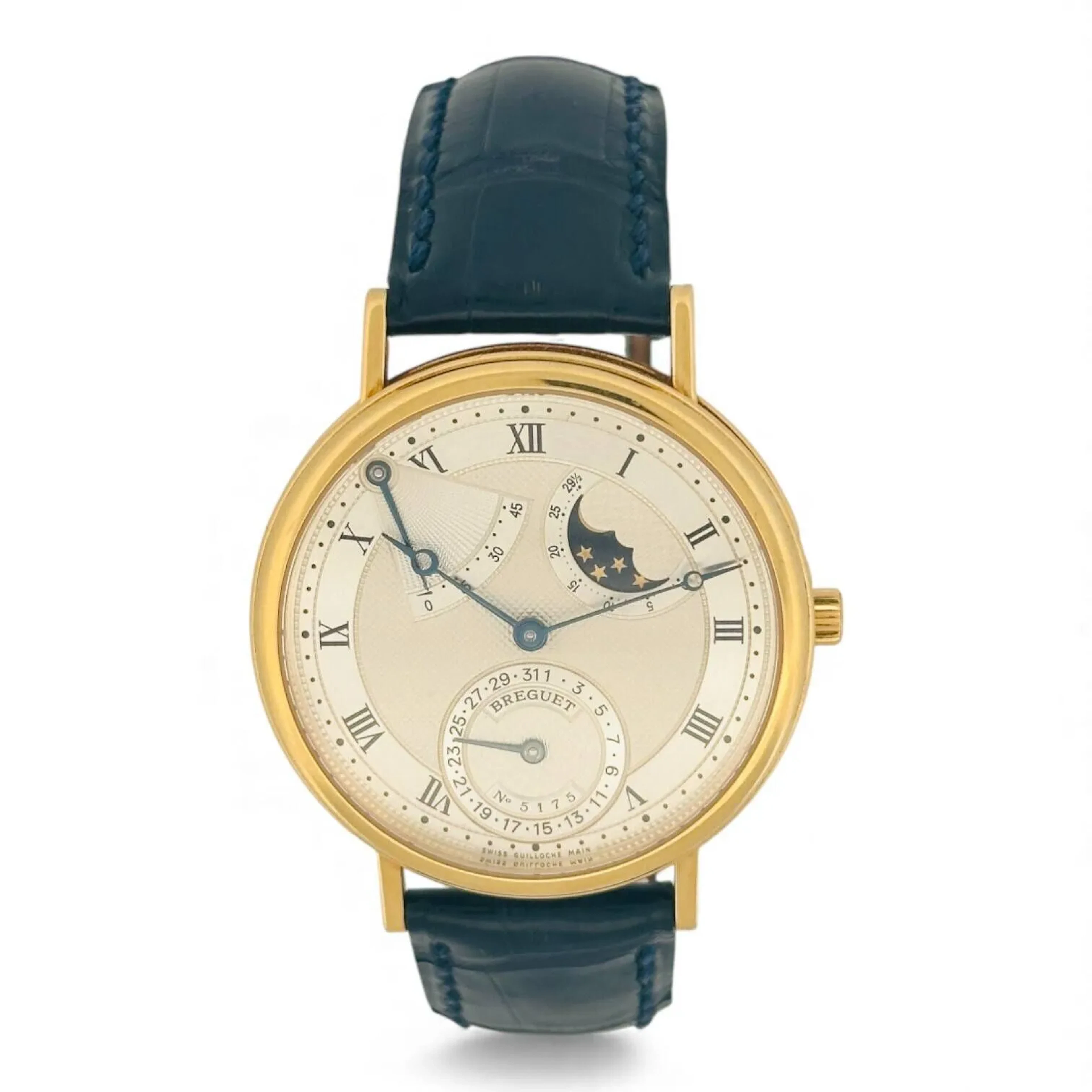 BREGUET CLASSIQUE RÉF. 3130 Montre bracelet en or 18K (750 millièmes), cadran argenté à différents guillochés, tour d’heure brossé avec guilloché de séparation minuterie, index des heures chiffres romains en décalques noires, date par aiguille à six heures, réserve de marche entre dix et onze heures, phases de Lune entre une et deux heures, aiguilles à pommes évidées bleuies. Fond clipé en or 18K (750 millièmes) signé Breguet référence 3130, numéro 5175B. Mouvement mécanique à remontage automatique signé Breguet. Bracelet en cuir noir, boucle ardillon en or 18K (750 millièmes) signée Breguet. Montre fonctionnelle lors de l’expertise, sans garantie de fonctionnement futur et d’état des pièces. Rayures au boitier. Vers 2000 Poids brut 64 g Diamètre 36 mm