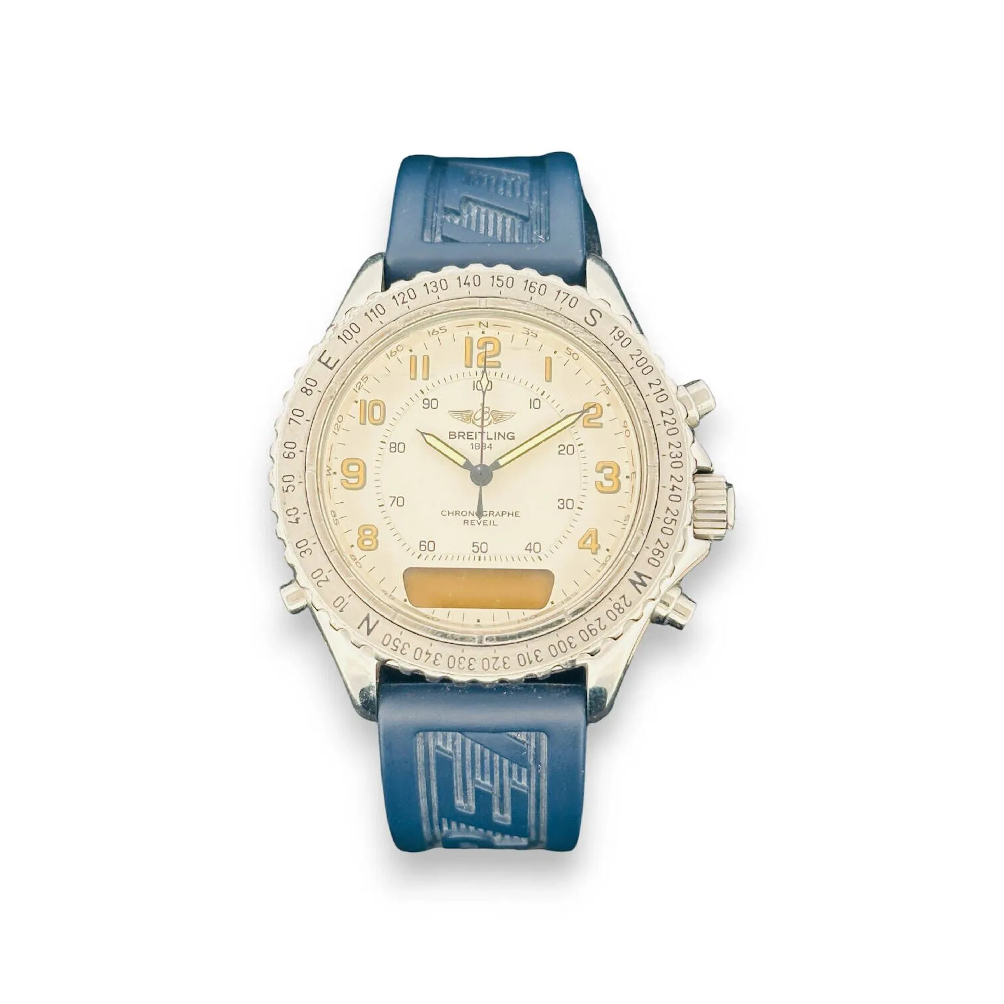 BREITLING Intruder N°A51035 Ref. 2833 Montre bracelet pour homme de type chronographe, boitier rond en acier, lunette tournante graduée, cadran blanc cassé, index chiffres arabes formant les heures, sous-cadran affichage analogique, mouvement quartz (pile non vérifiée), bracelet intégré en silicone bleu signé et à boucle ardillon siglée. Cadran et boitier signés. Conservée dans son écrin en bakélite avec sa garantie et ses papiers. Diam. : 40 mm.