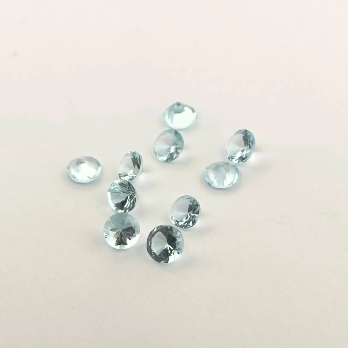 Lot of ten round aquamarines on paper. - Lot 91