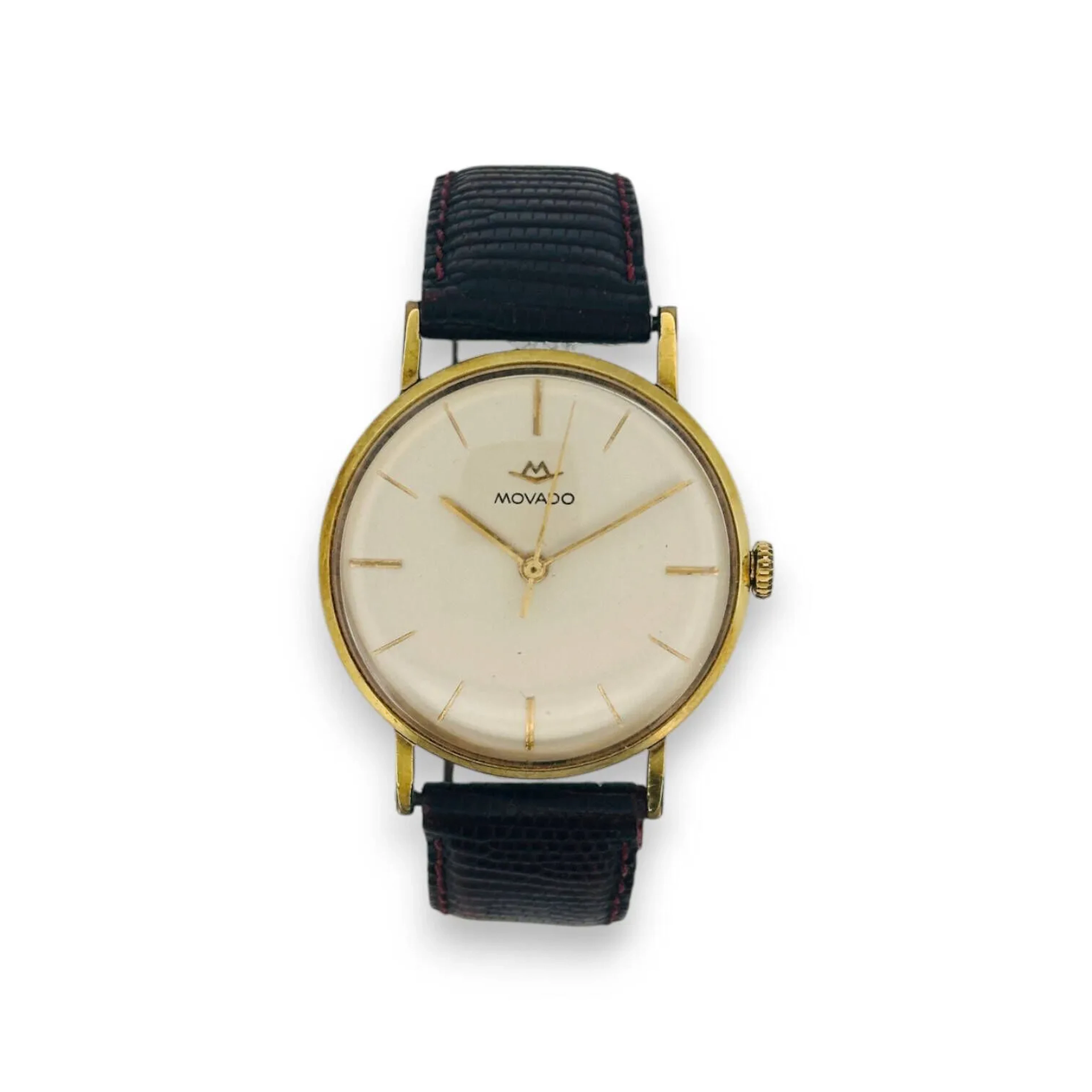 MOVADO Montre bracelet d'homme, la lunette ronde en métal doré, index bâtons dorés sur fond blanc. Mouvement mécanique à remontoir. Bracelet en cuir marron (état d'usage). Fonctionnelle, révision à prévoir.