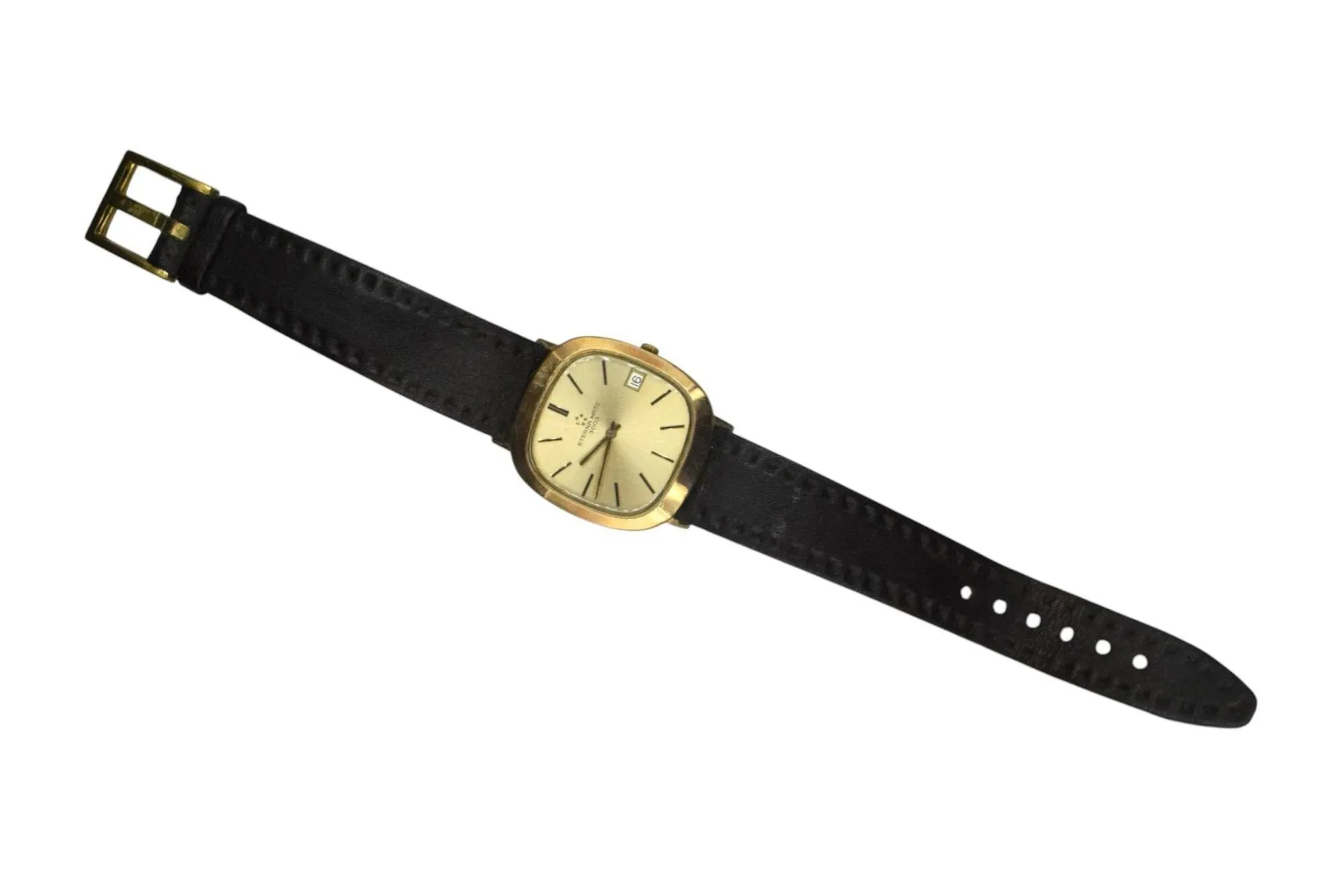 ETERNA MATIC Montre bracelet d'homme, modèle 3003 à mouvement automatique. Index bâtons dorés sur fond or, guichet dateur à 3 h ; bracelet en cuir marron. Fonctionnelle, révision à prévoir.