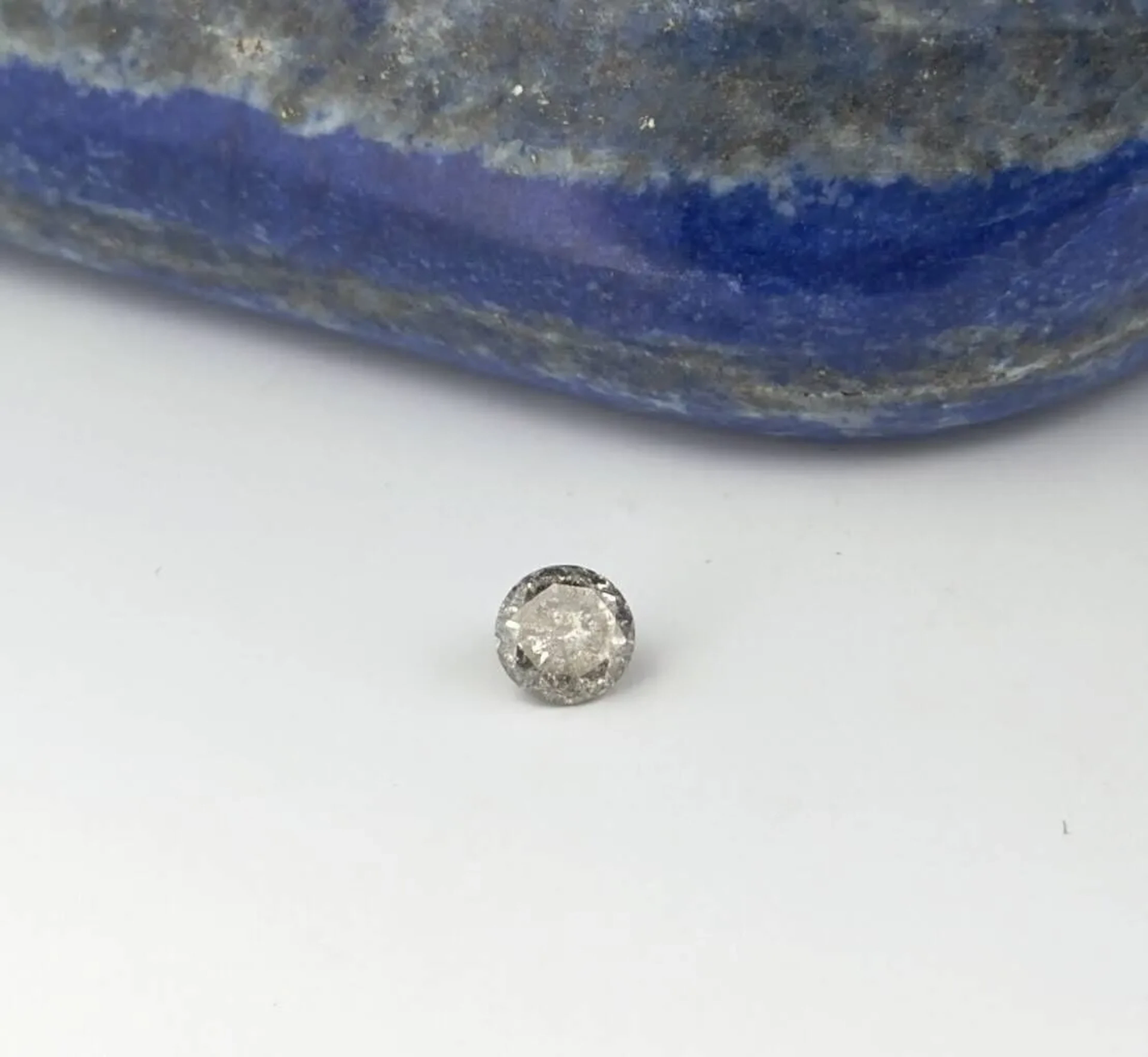 Round modern cut diamond on paper weighing 0.52 carat. It is - Lot 368