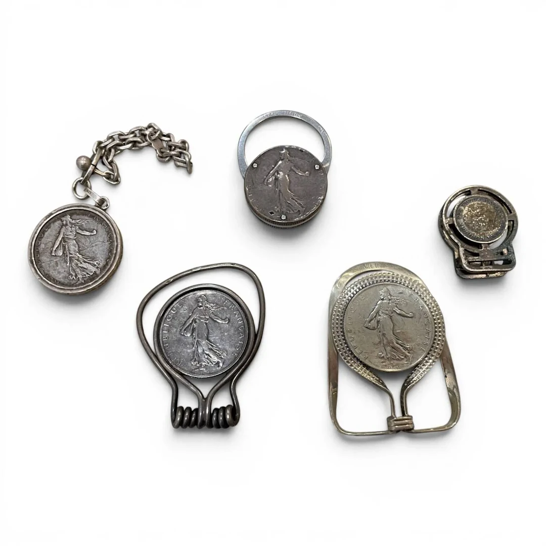 Set of three clips—two made of silver (800 min.) and metal, - Lot 87